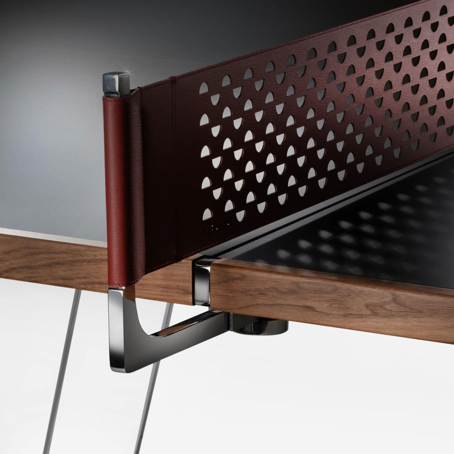 Stylish modern desk with wooden top, perforated leather privacy panel, and sleek metal accents.