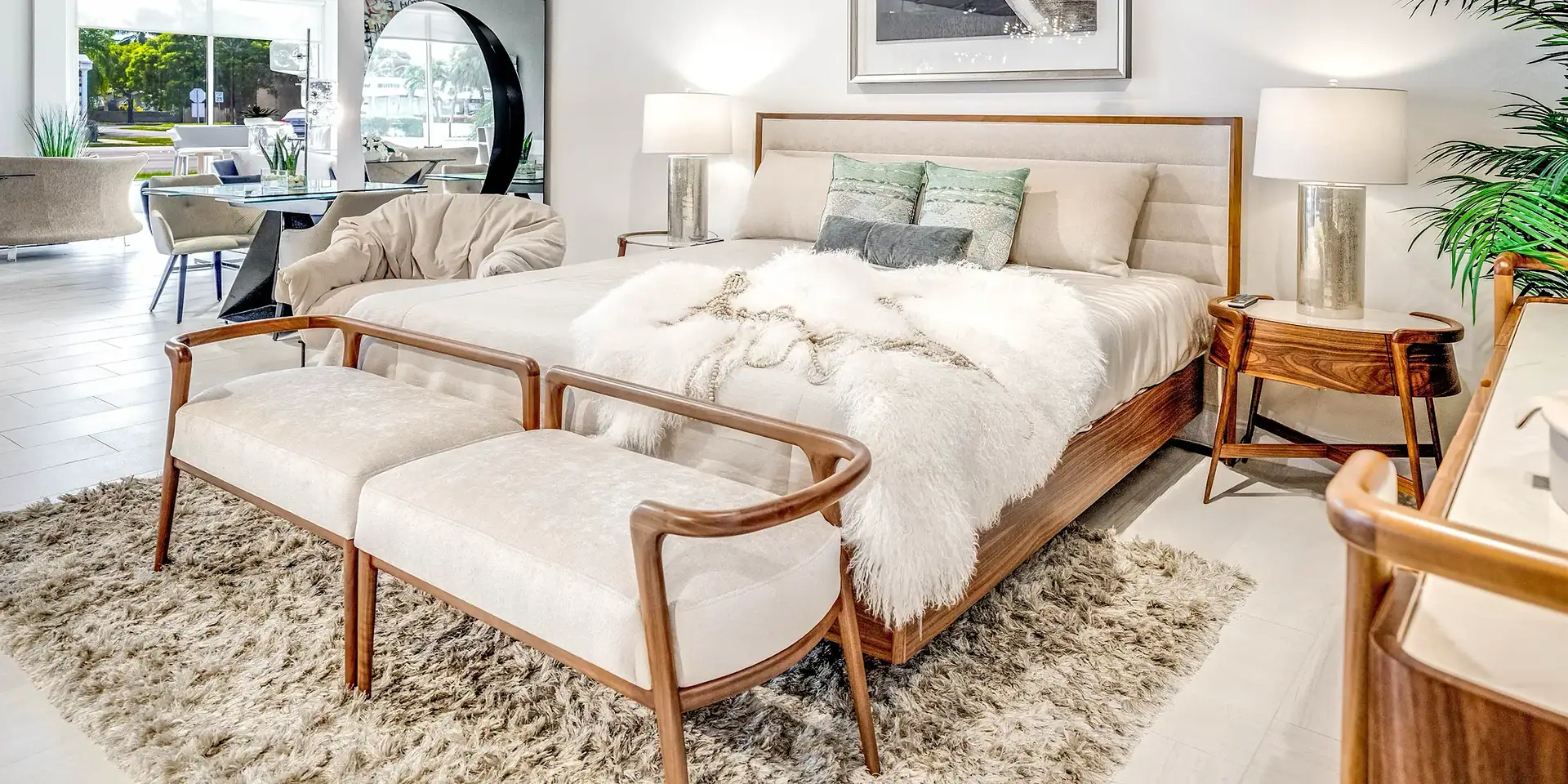 Contemporary bedroom with wooden furniture, plush bedding, and elegant lighting, featuring modern and minimalist design elements.