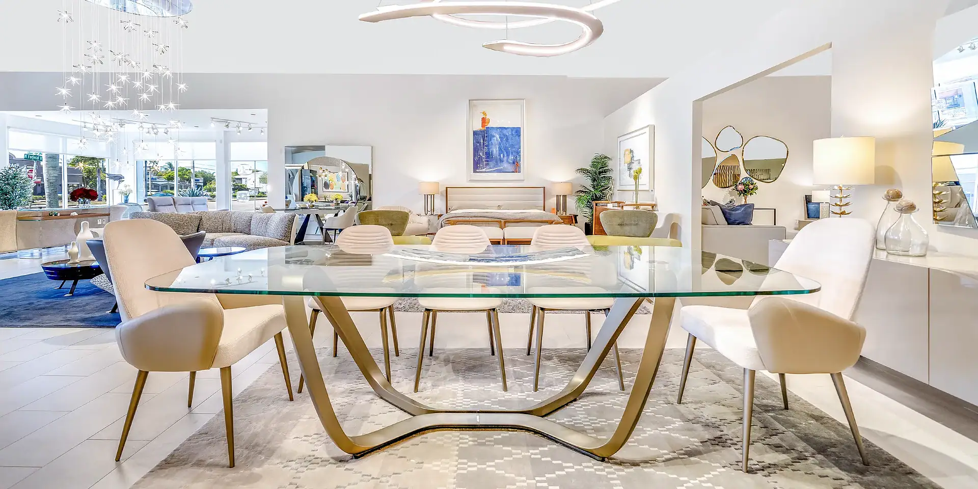 Elegant modern dining room with glass table and designer chairs, showcasing high-end furniture by Sklar Furnishings.