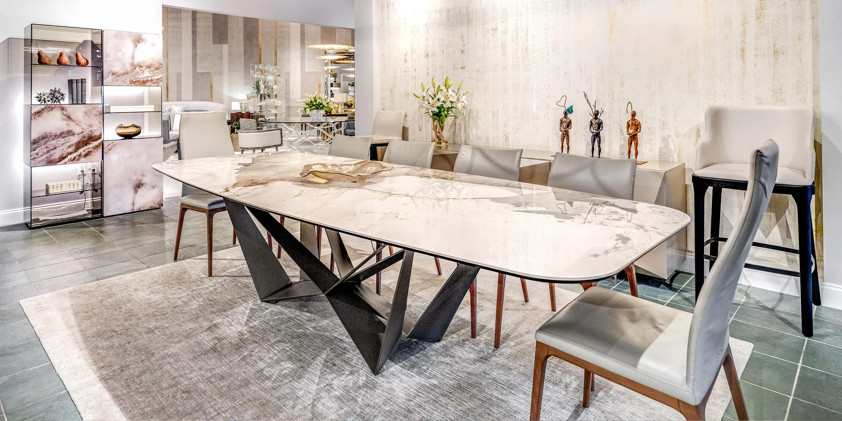 Contemporary dining room with marble table and stylish seating, showcasing elegant modern furniture from Sklar Furnishings.