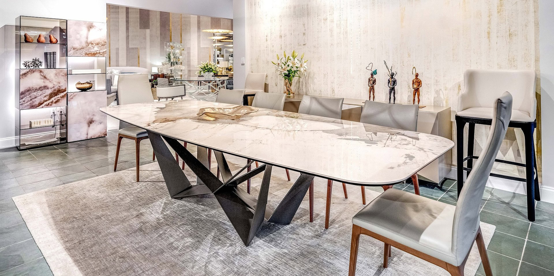 Contemporary dining room with marble table and stylish seating, showcasing elegant modern furniture from Sklar Furnishings.