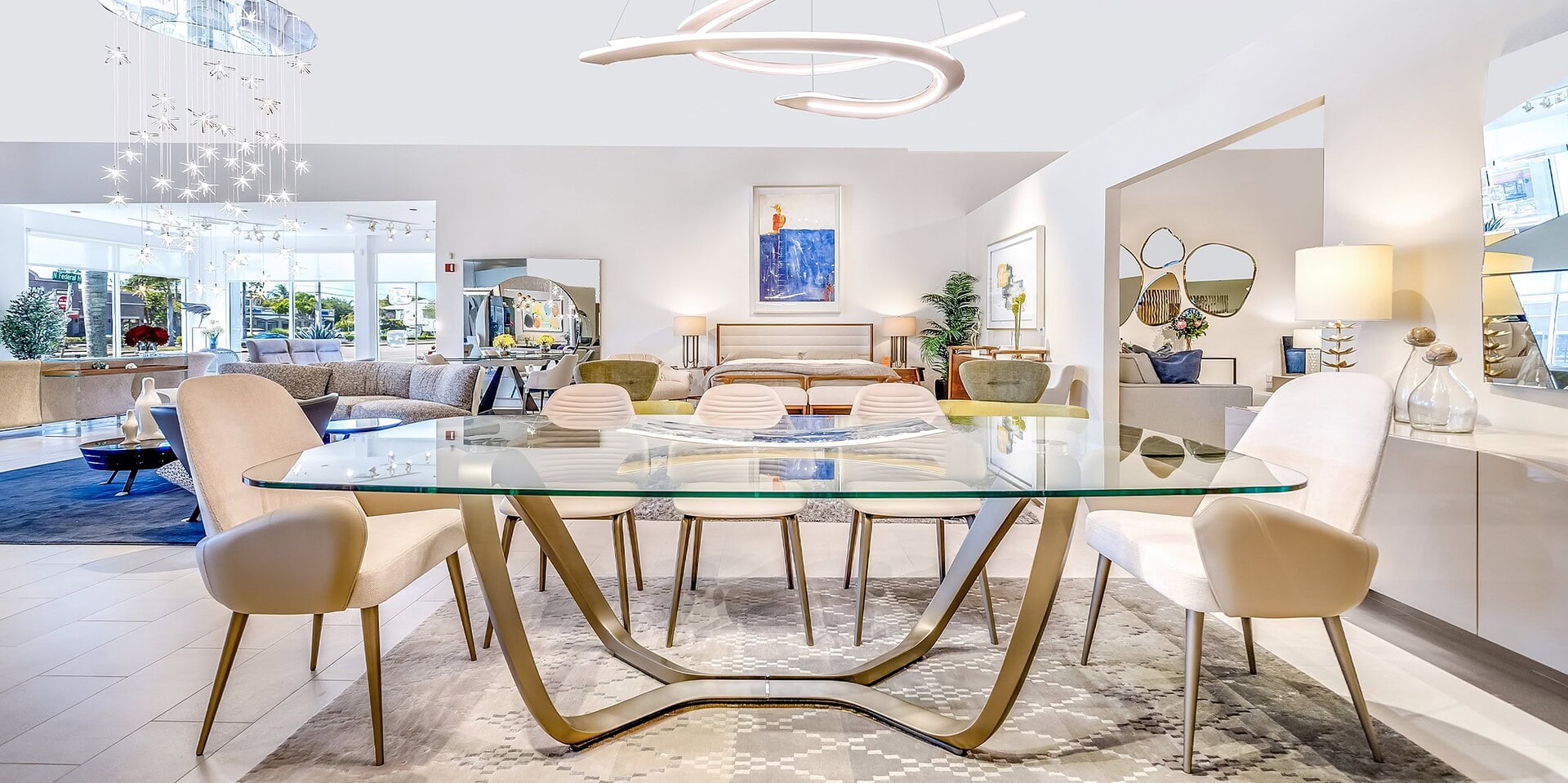 Elegant modern dining room with glass table and designer chairs, showcasing high-end furniture by Sklar Furnishings.