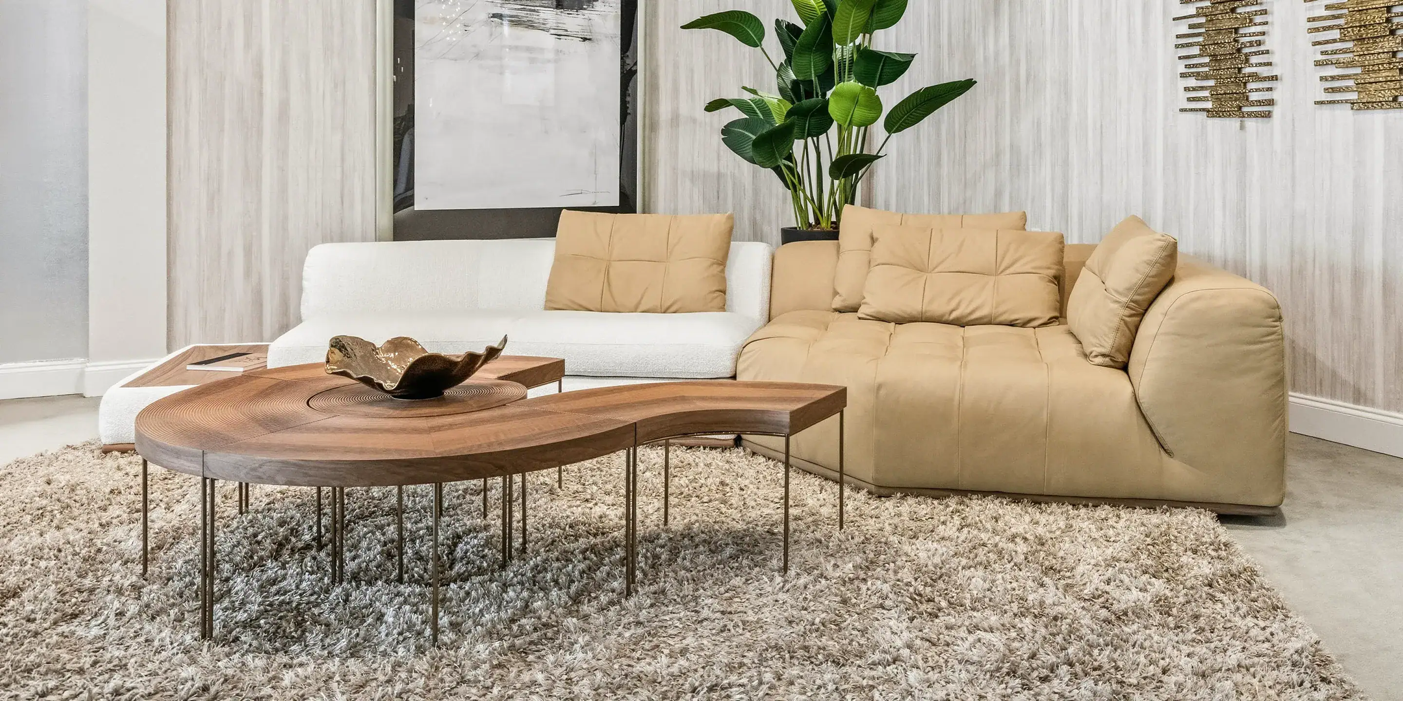 Modern beige and white sectional sofas with wooden coffee table in contemporary living room setting.