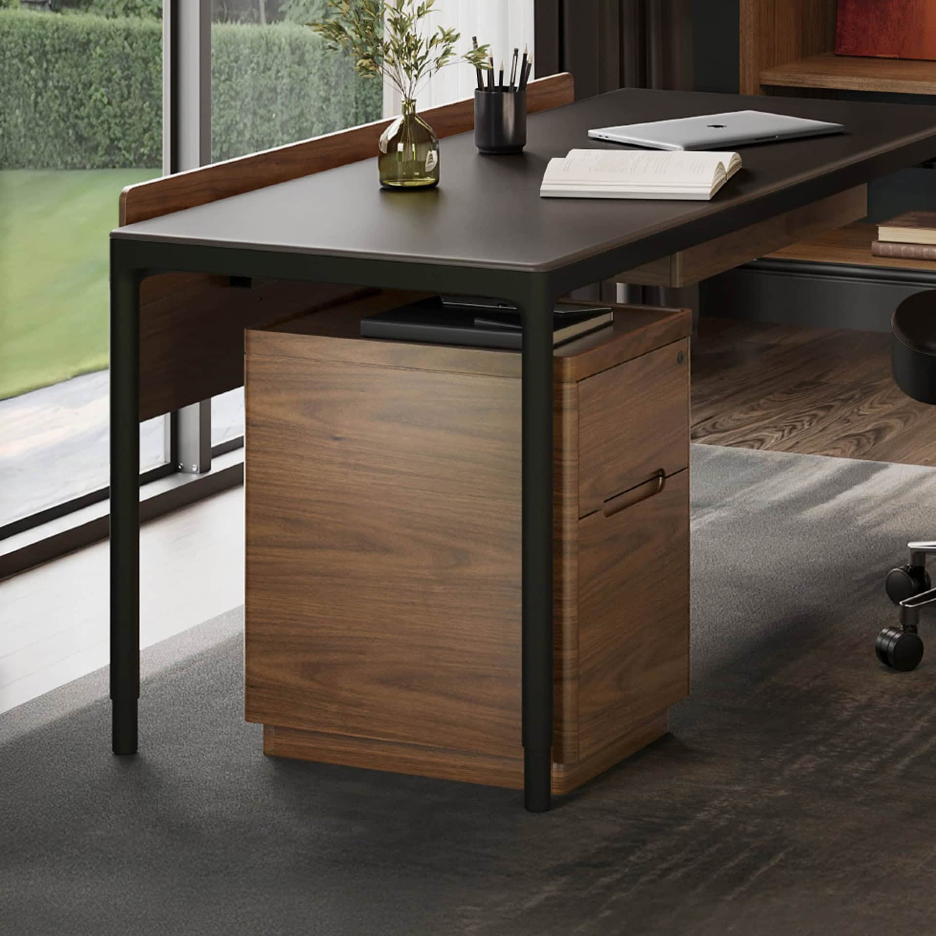Stylish office workspace featuring a black desk with a wooden filing cabinet underneath.