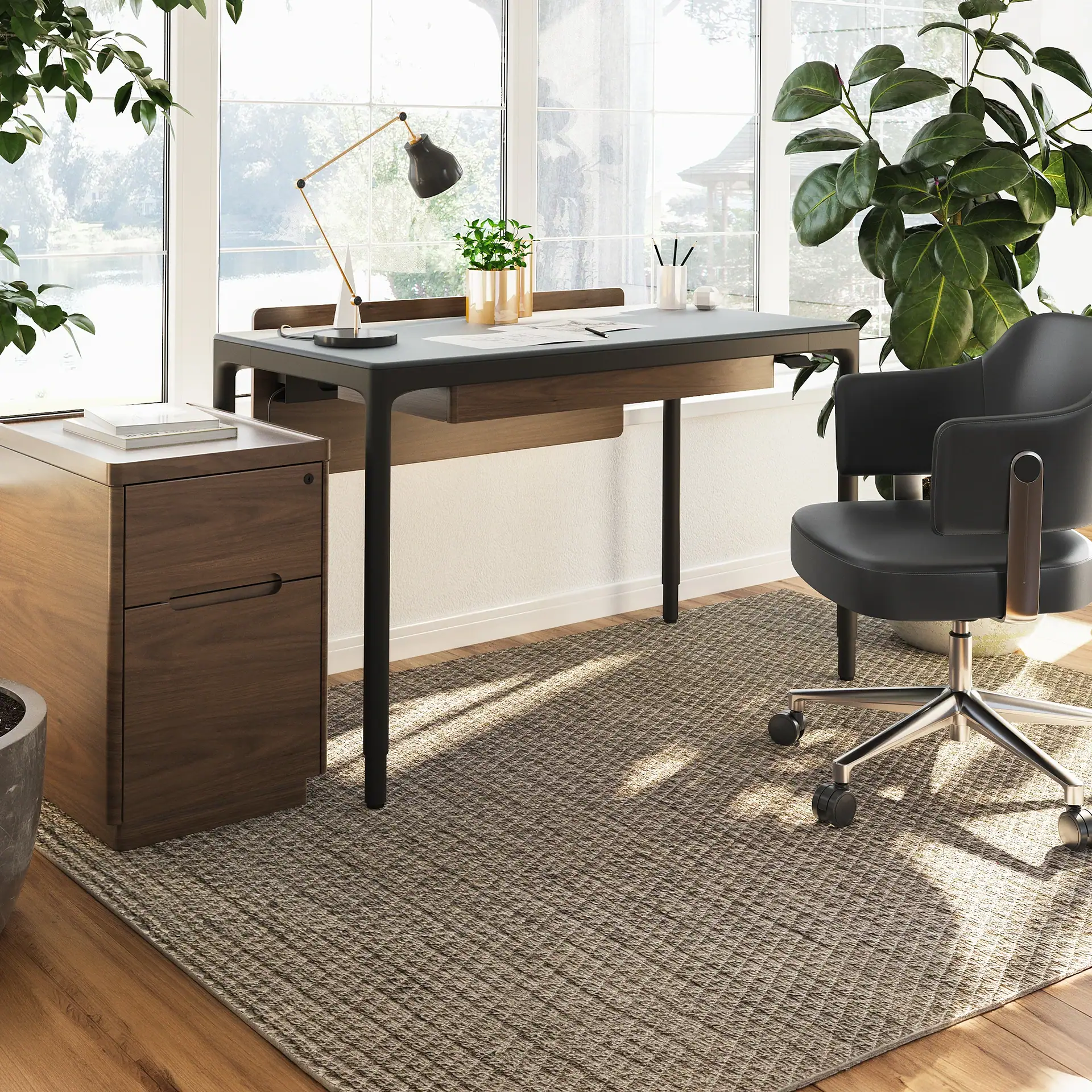 Modern white height-adjustable standing desk with a laptop and desk lamp.