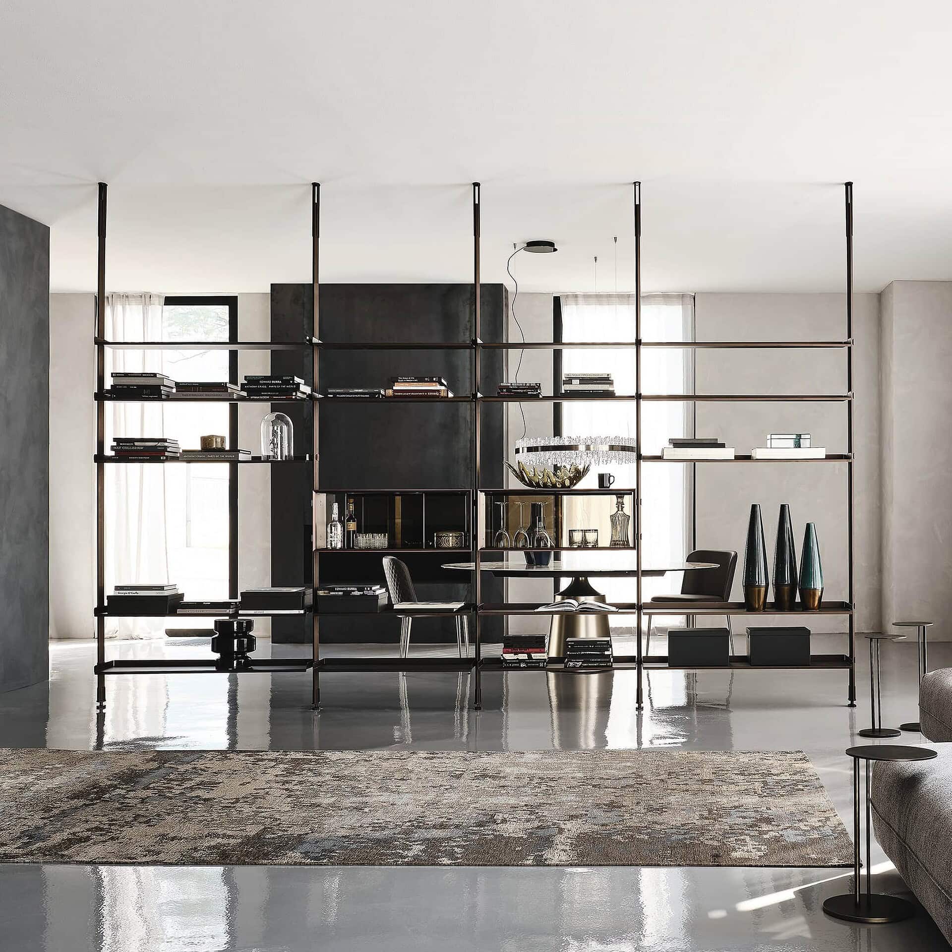 Contemporary open shelving unit in a modern living room with black metal frame and decorative objects.