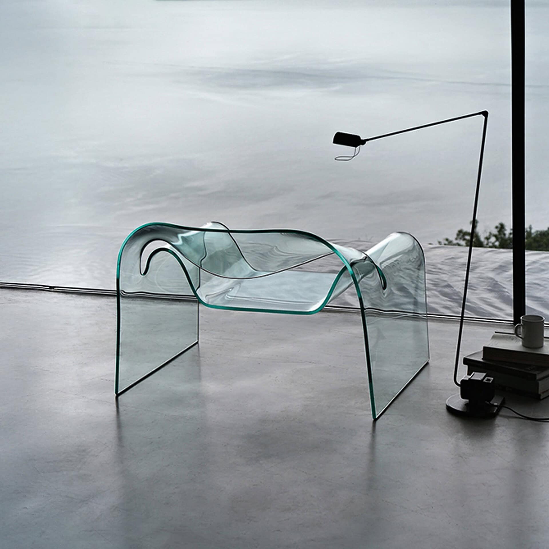 Sleek transparent glass lounge chair with modern minimalist design, perfect for contemporary home decor.