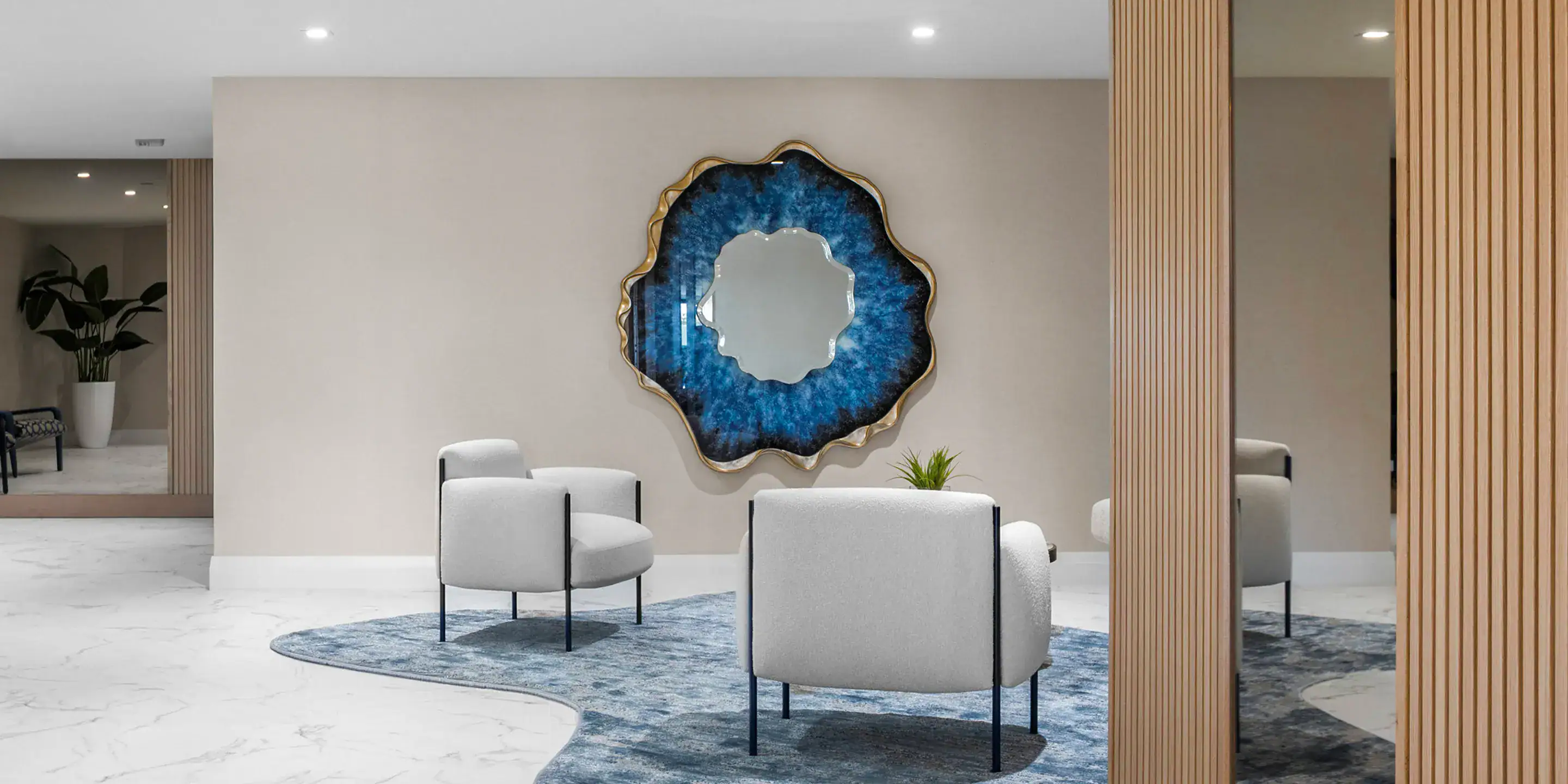 Contemporary living room with modern sofa, white armchairs, decorative wall art, and stylish wooden partitions.