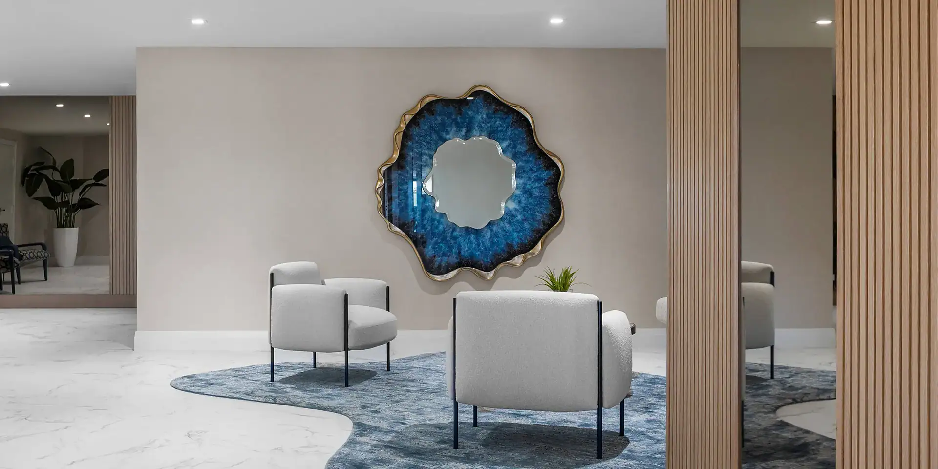 Contemporary living room with modern sofa, white armchairs, decorative wall art, and stylish wooden partitions.