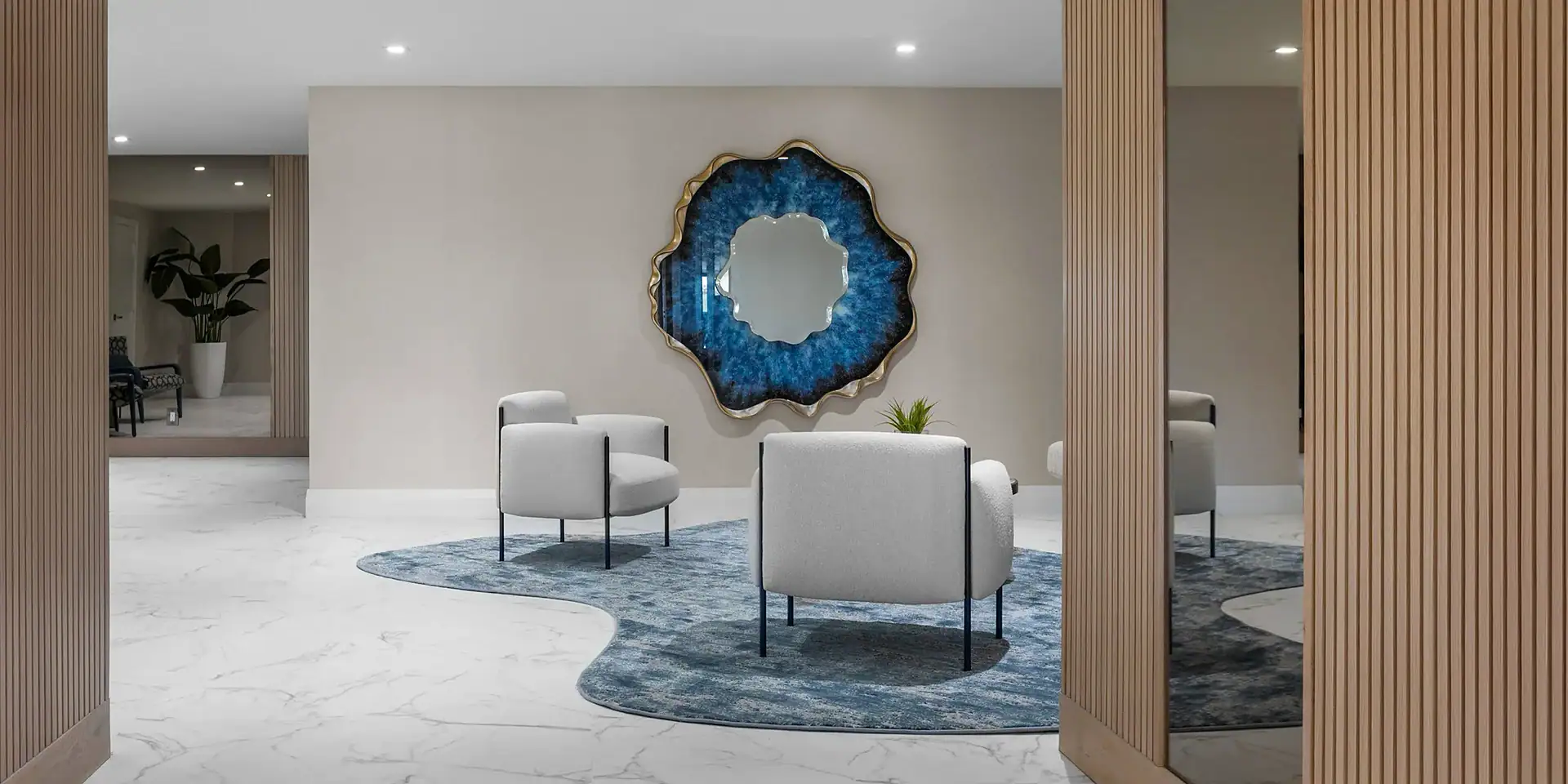 Contemporary living room with modern sofa, white armchairs, decorative wall art, and stylish wooden partitions.