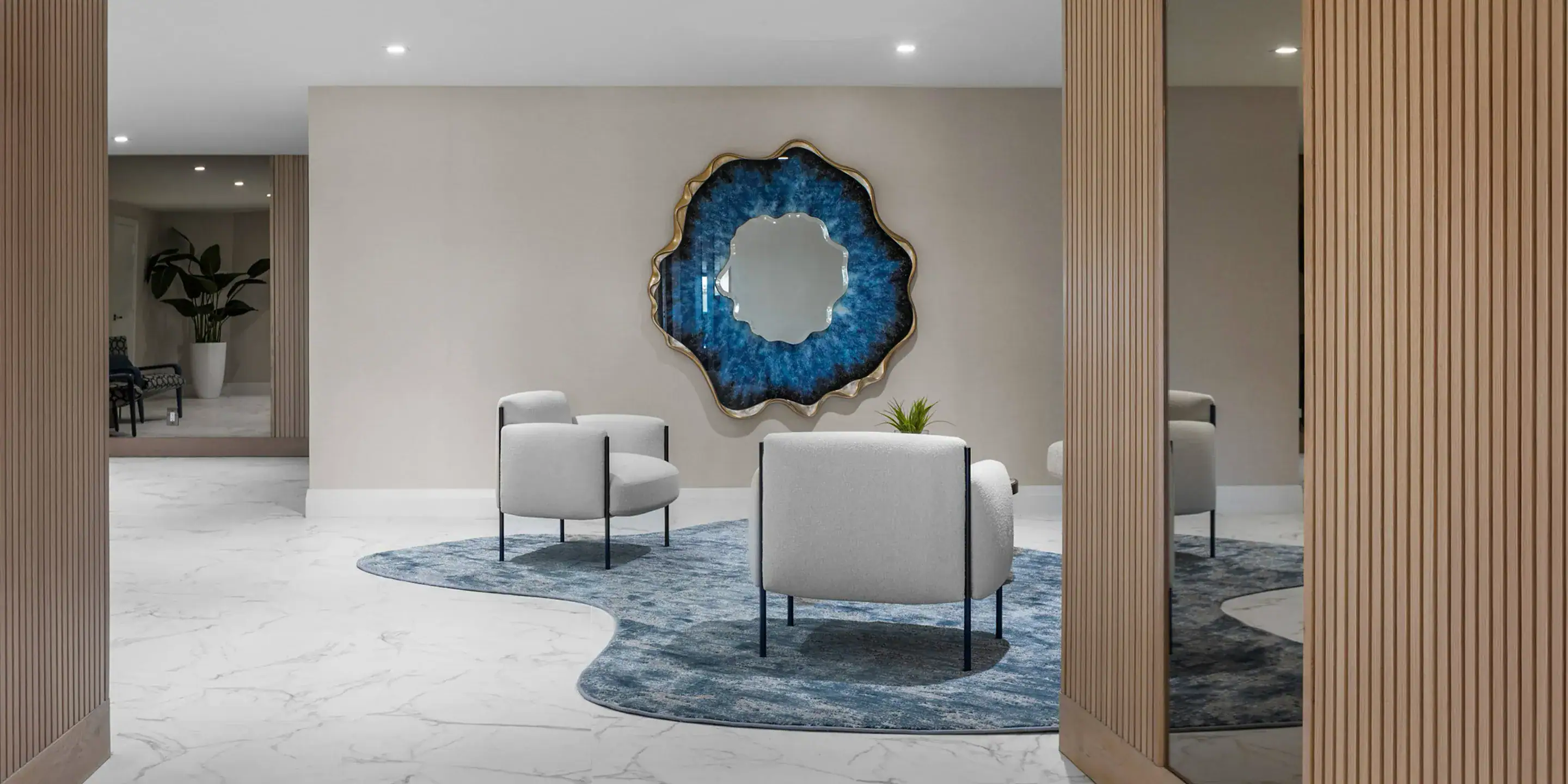 Contemporary living room with modern sofa, white armchairs, decorative wall art, and stylish wooden partitions.