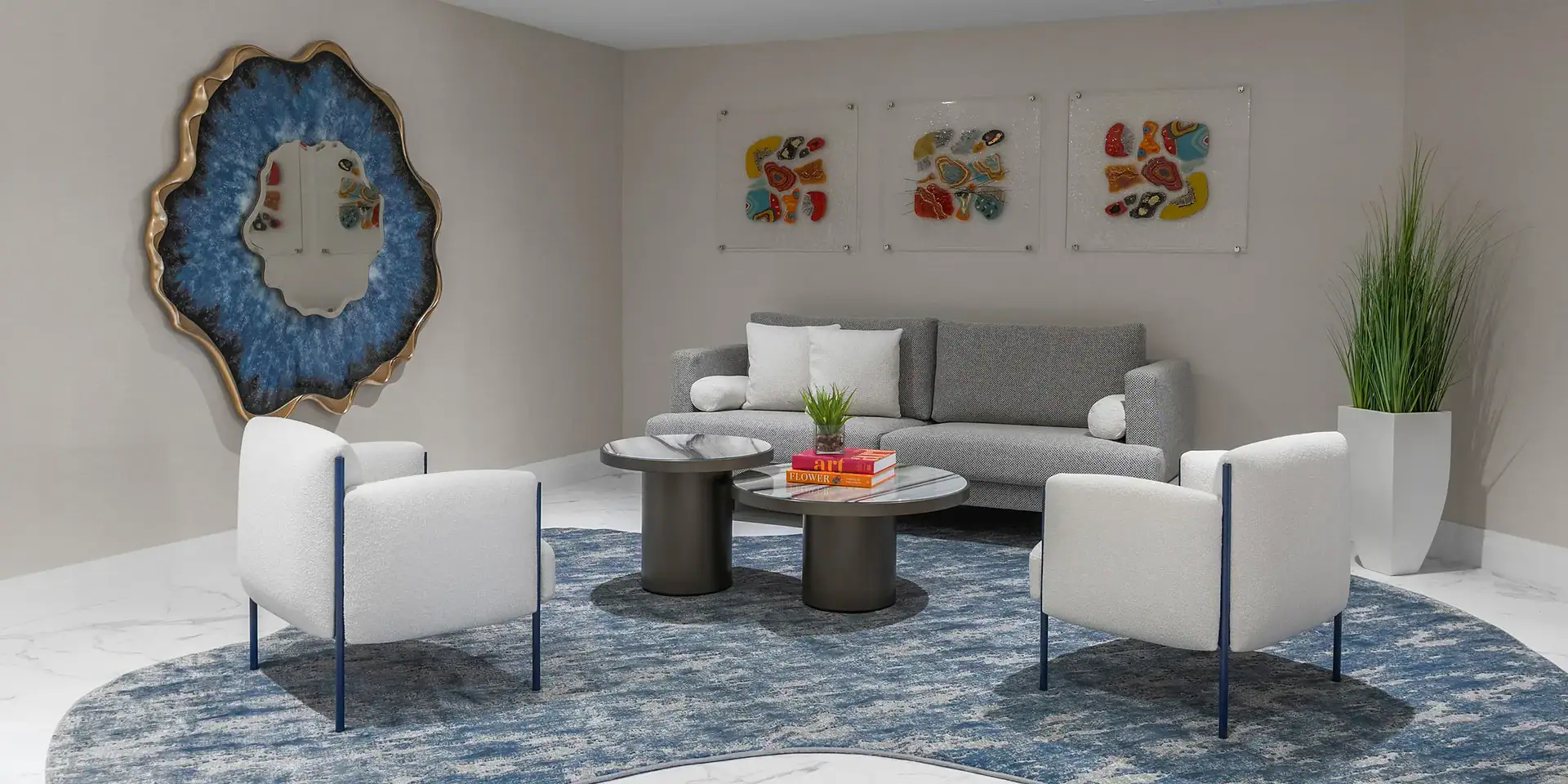 Modern hotel lobby with stylish seating and contemporary decor, featuring blue patterned chairs and wall mirrors.