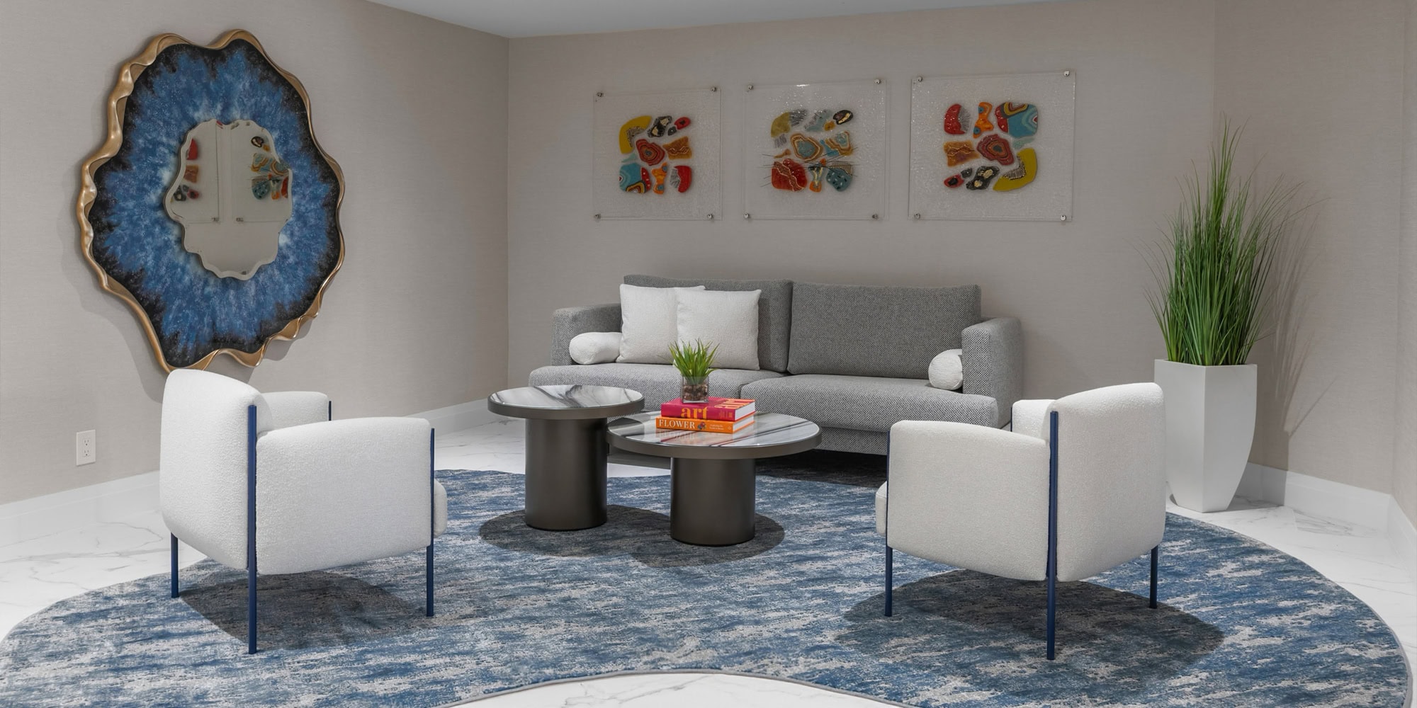 Modern living room with stylish furniture and colorful artwork, showcasing Sklar Furnishings' design expertise.