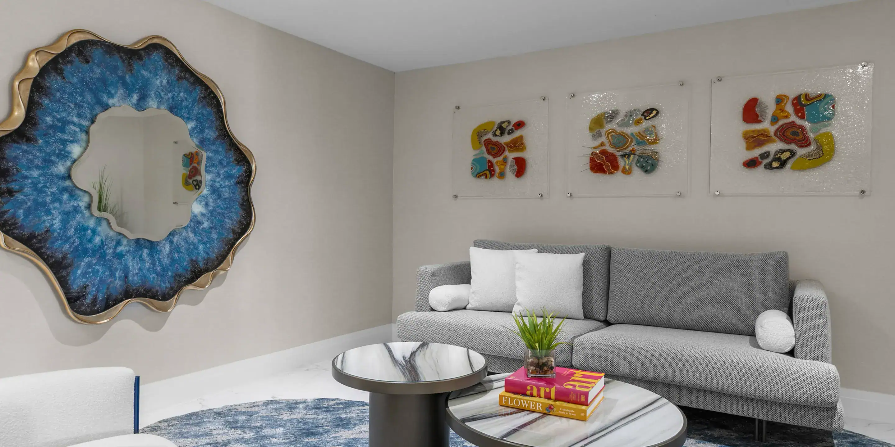 Modern living room with stylish furniture and colorful artwork, showcasing Sklar Furnishings' design expertise.