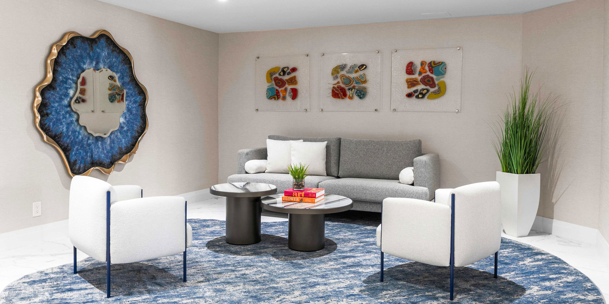Modern living room with stylish furniture and colorful artwork, showcasing Sklar Furnishings' design expertise.