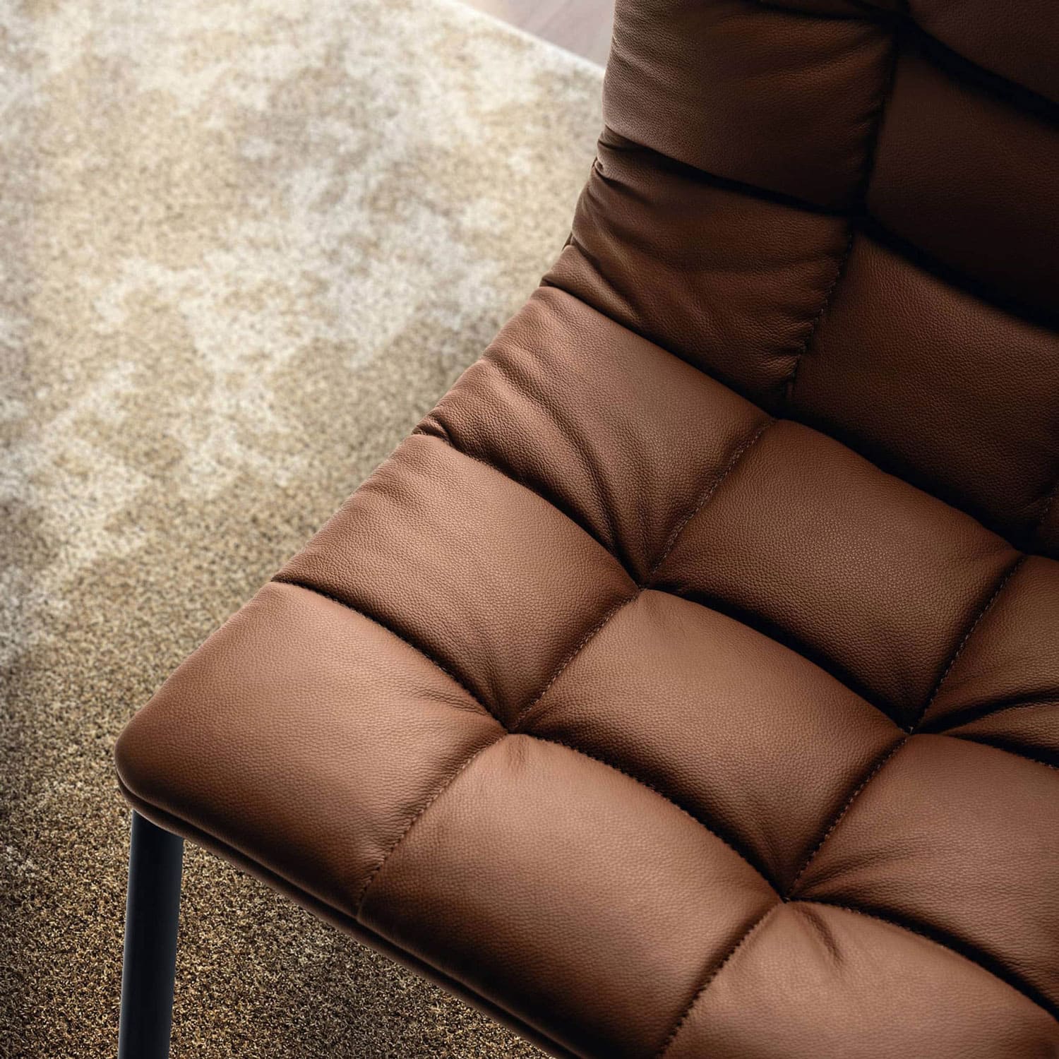 Luxurious brown leather tufted modern accent chair for stylish living rooms.