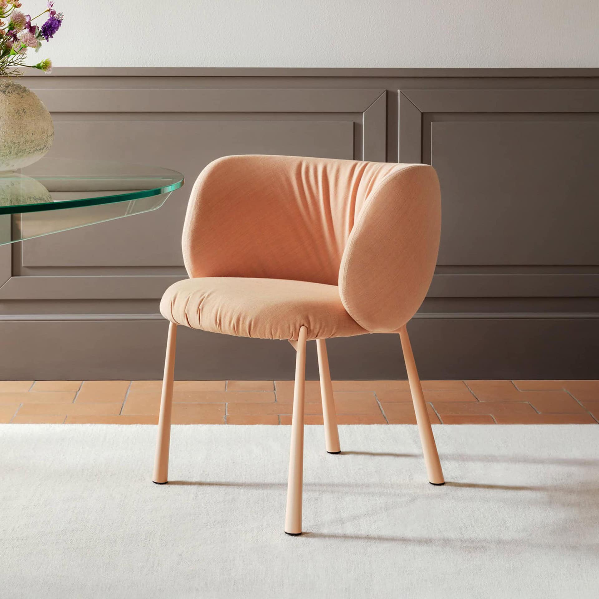 Comfortable peach upholstered accent chair with modern design for living room decor.
