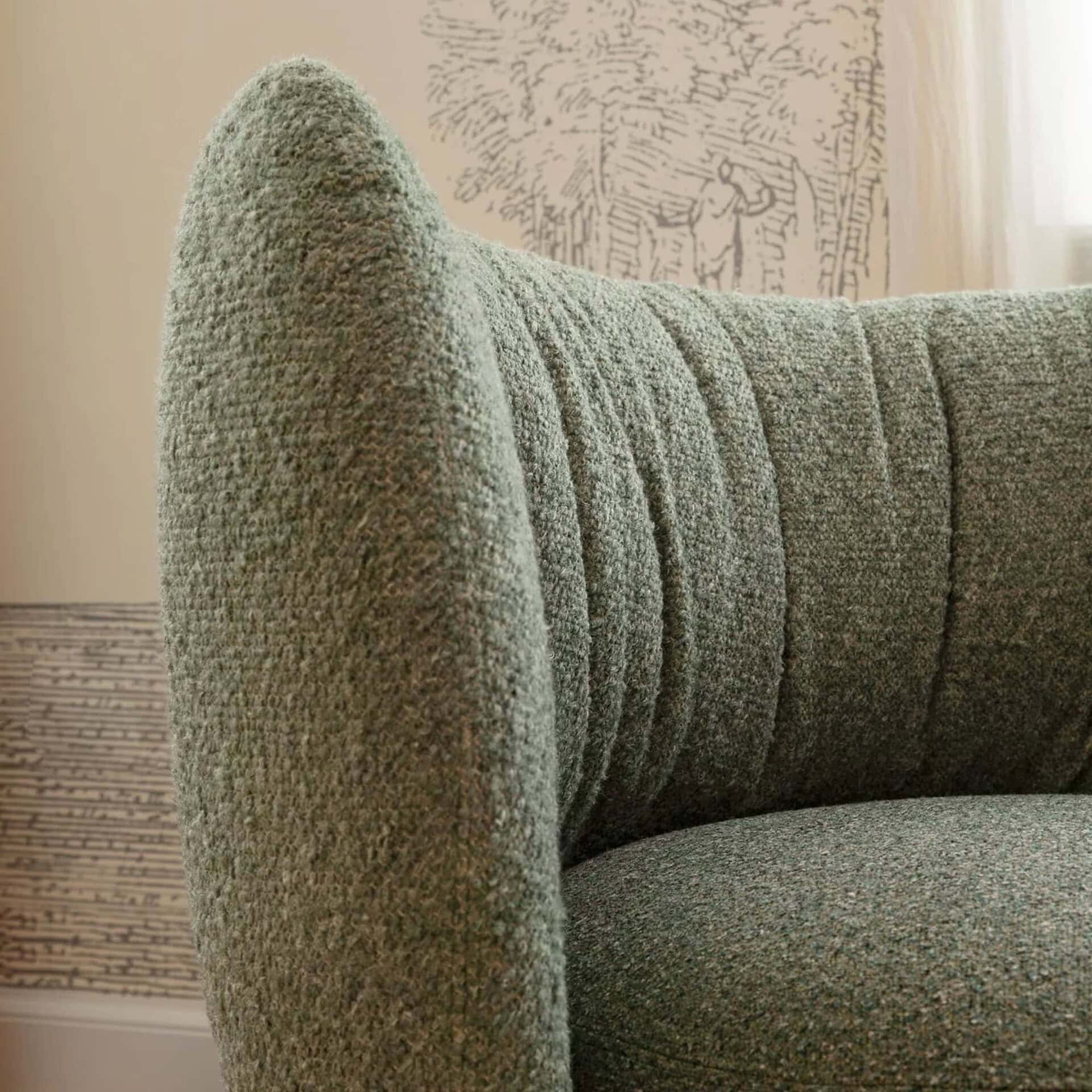 Luxurious textured green upholstered sofa with modern design elements.