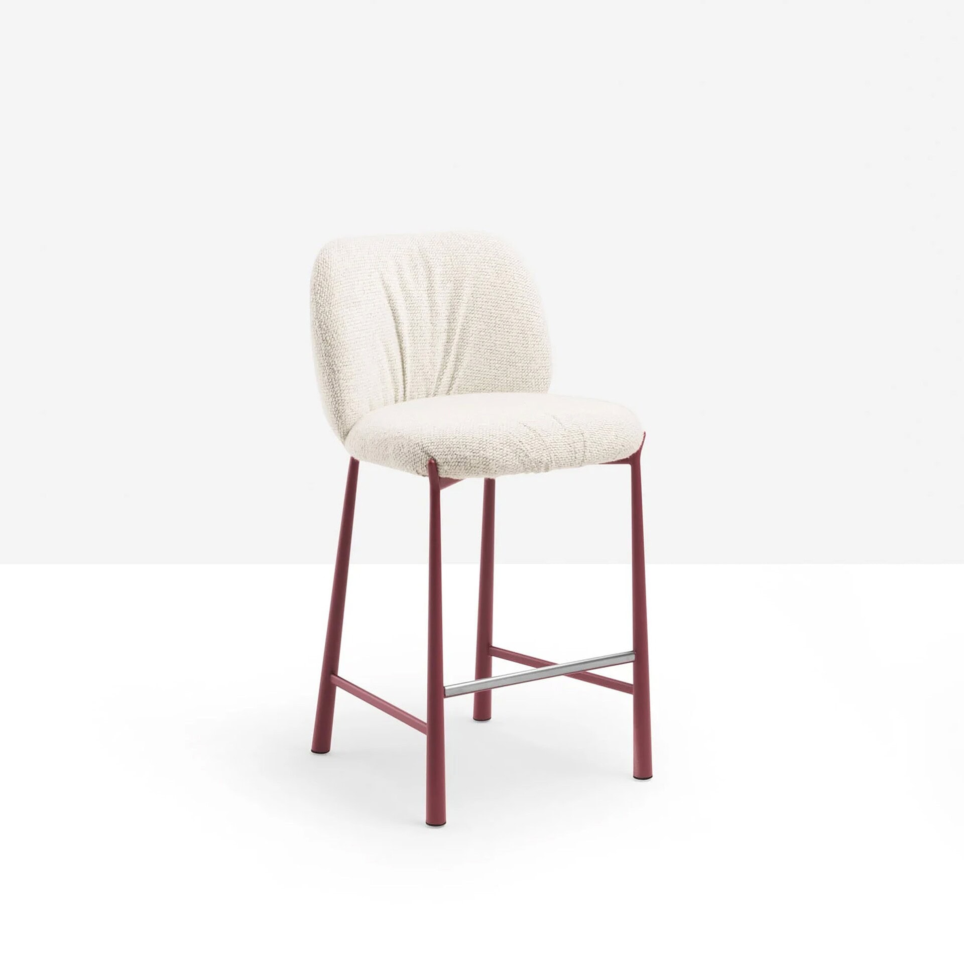Comfortable upholstered barstool with pink metal frame and plush cream fabric cushion.
