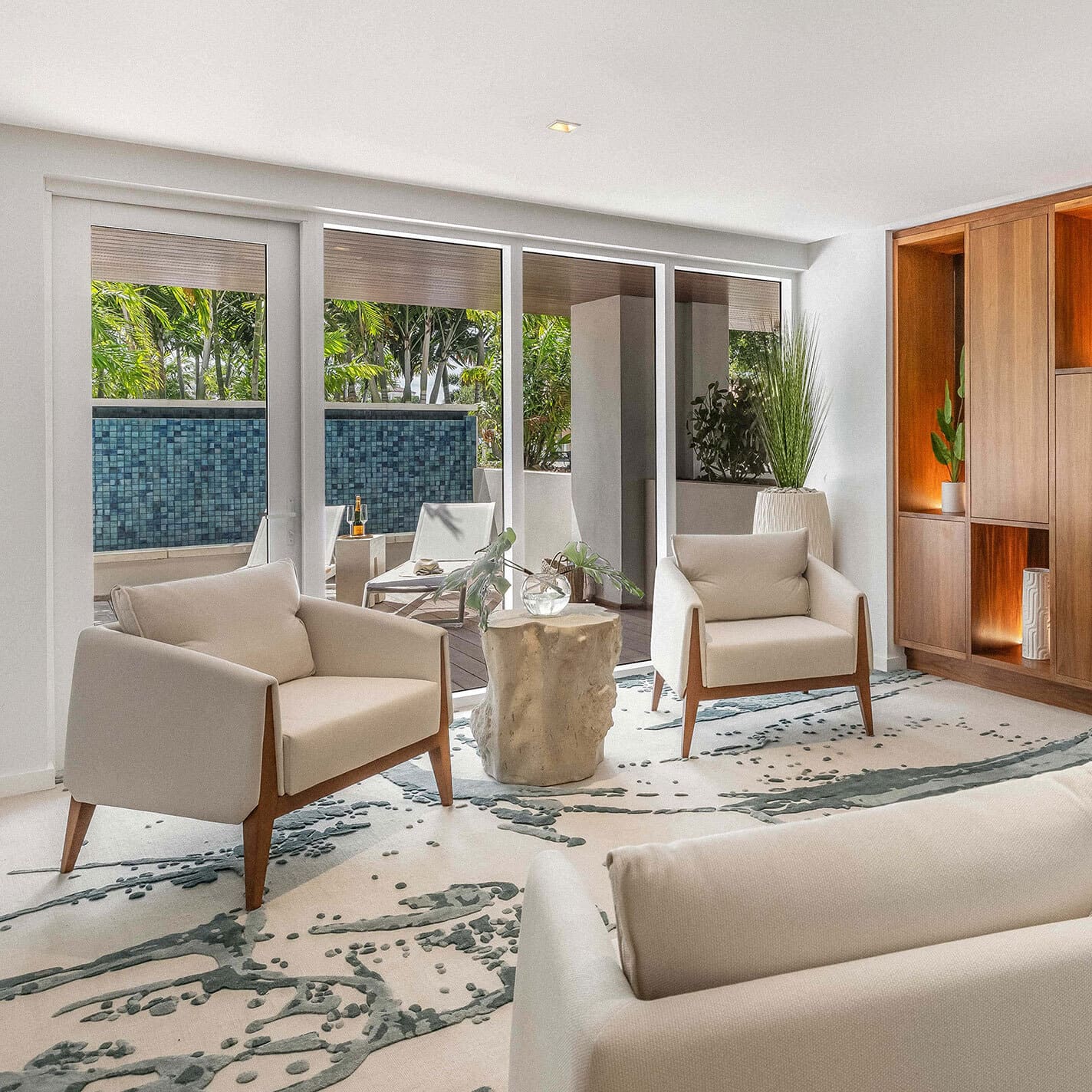 Modern living room with elegant neutral furniture and natural decor, seamless indoor-outdoor space with tropical views.