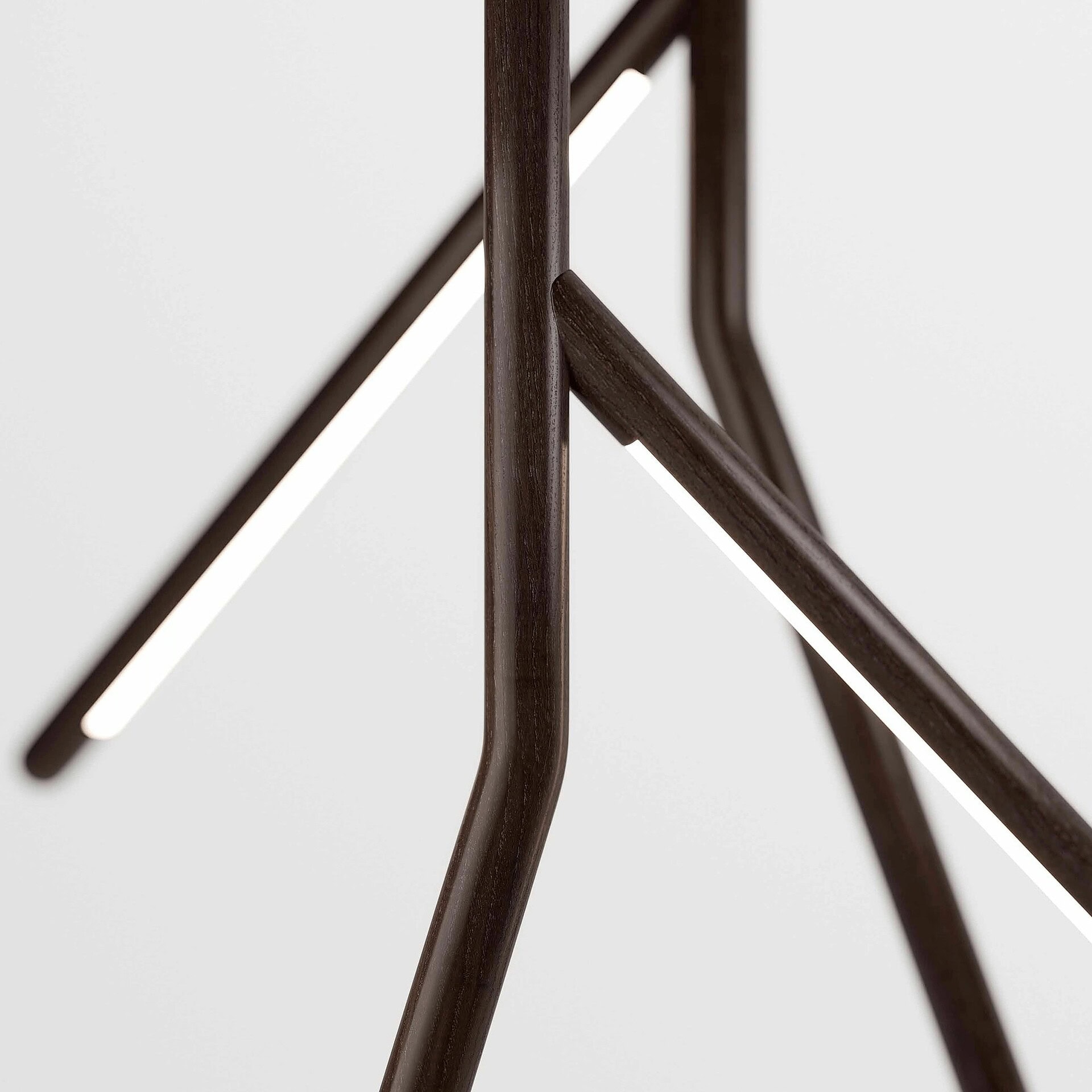 Sleek dark wooden table leg with modern design, high-quality craftsmanship.