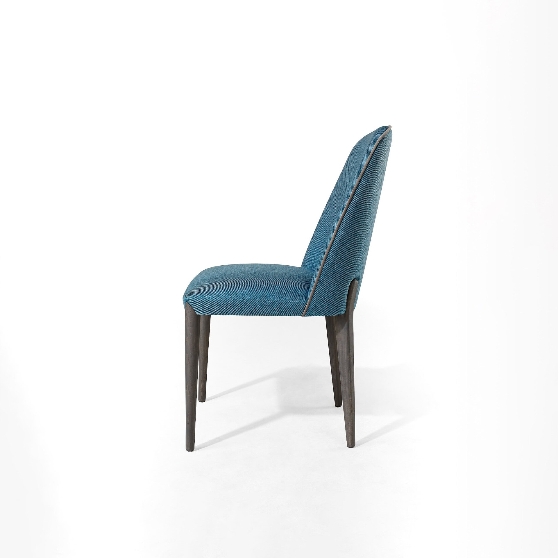 Stylish blue fabric dining chair with sleek wooden legs and modern design, perfect for contemporary homes.