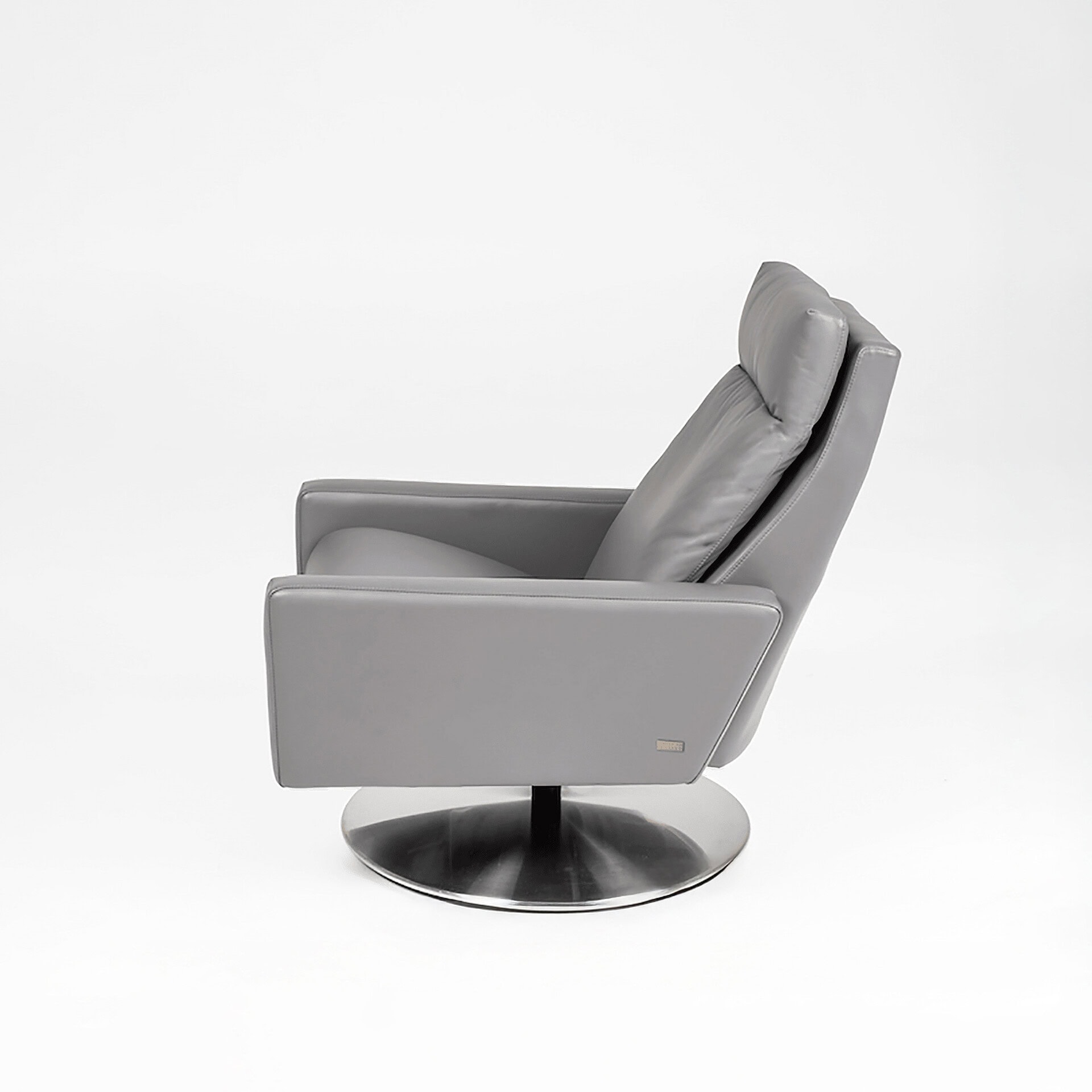 Recliner chair in gray leather with plush cushioning, perfect for relaxing in a modern living room s.