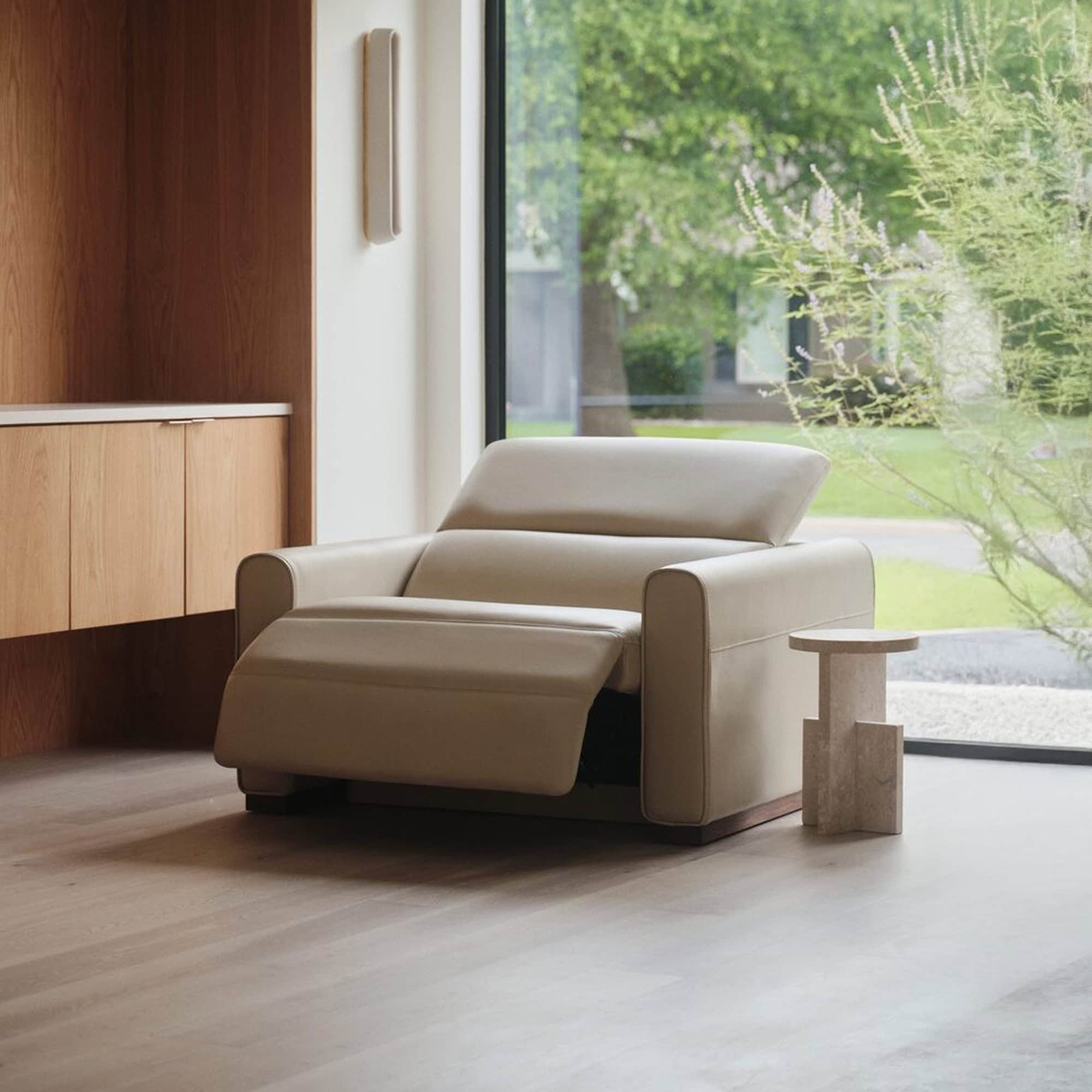 Luxurious cream leather armchair with modern design and built-in recliner. Perfect for stylish, comfortable living rooms.