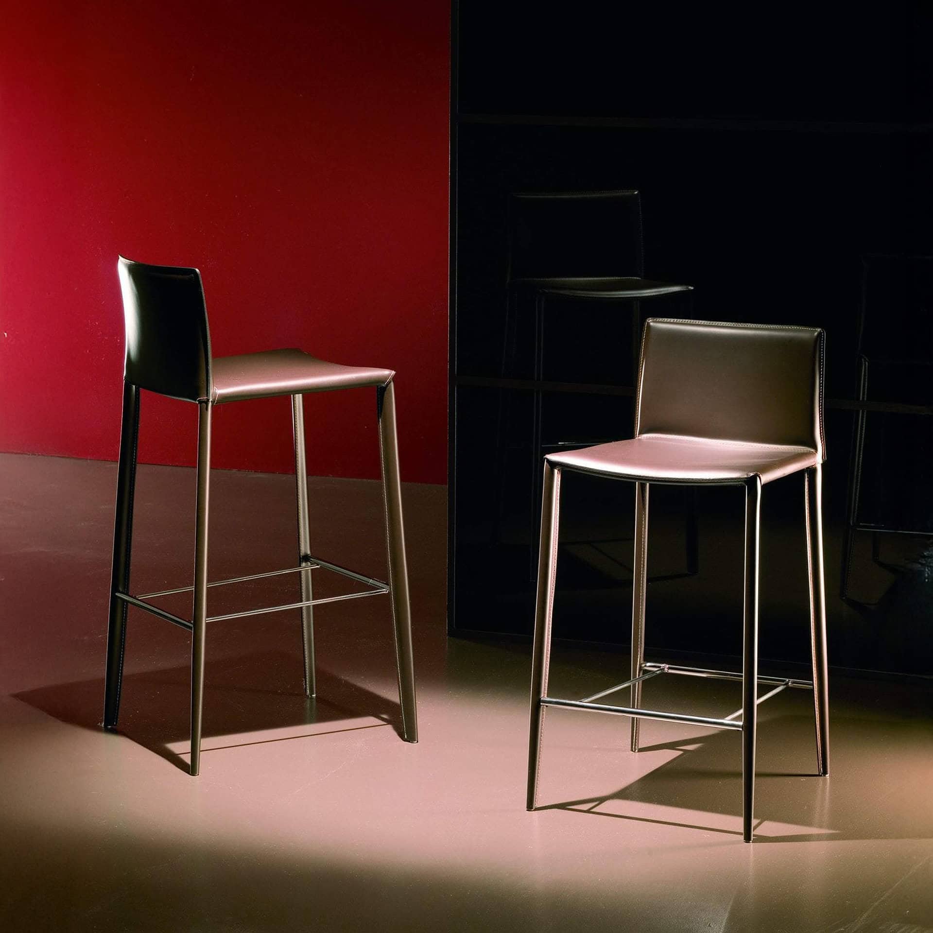 Stylish contemporary bar stools with leather seats and metal frames, ideal for modern kitchens, bars, and dining areas.