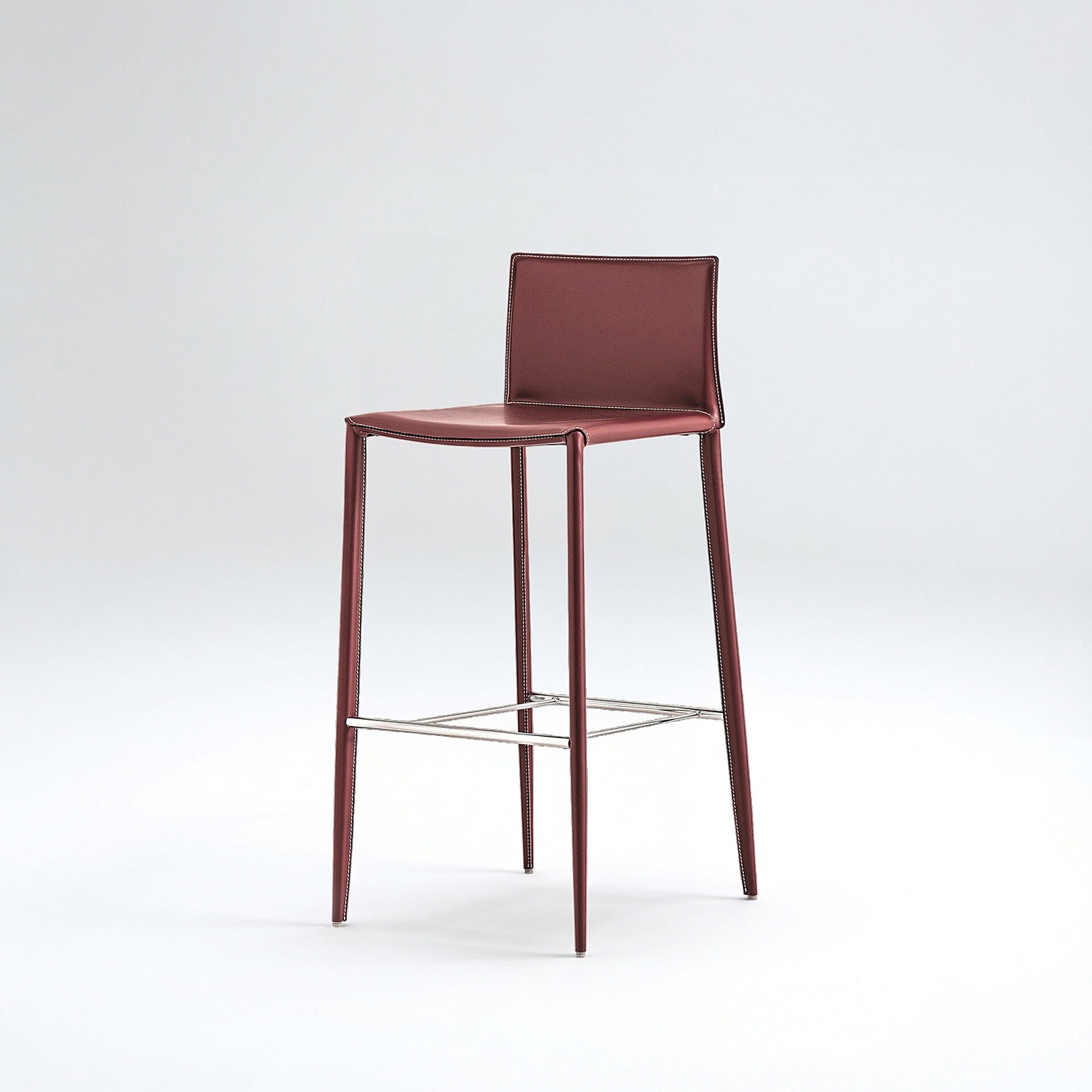 Sleek burgundy leather bar stool featuring chrome accents, ideal for contemporary kitchens and bars.