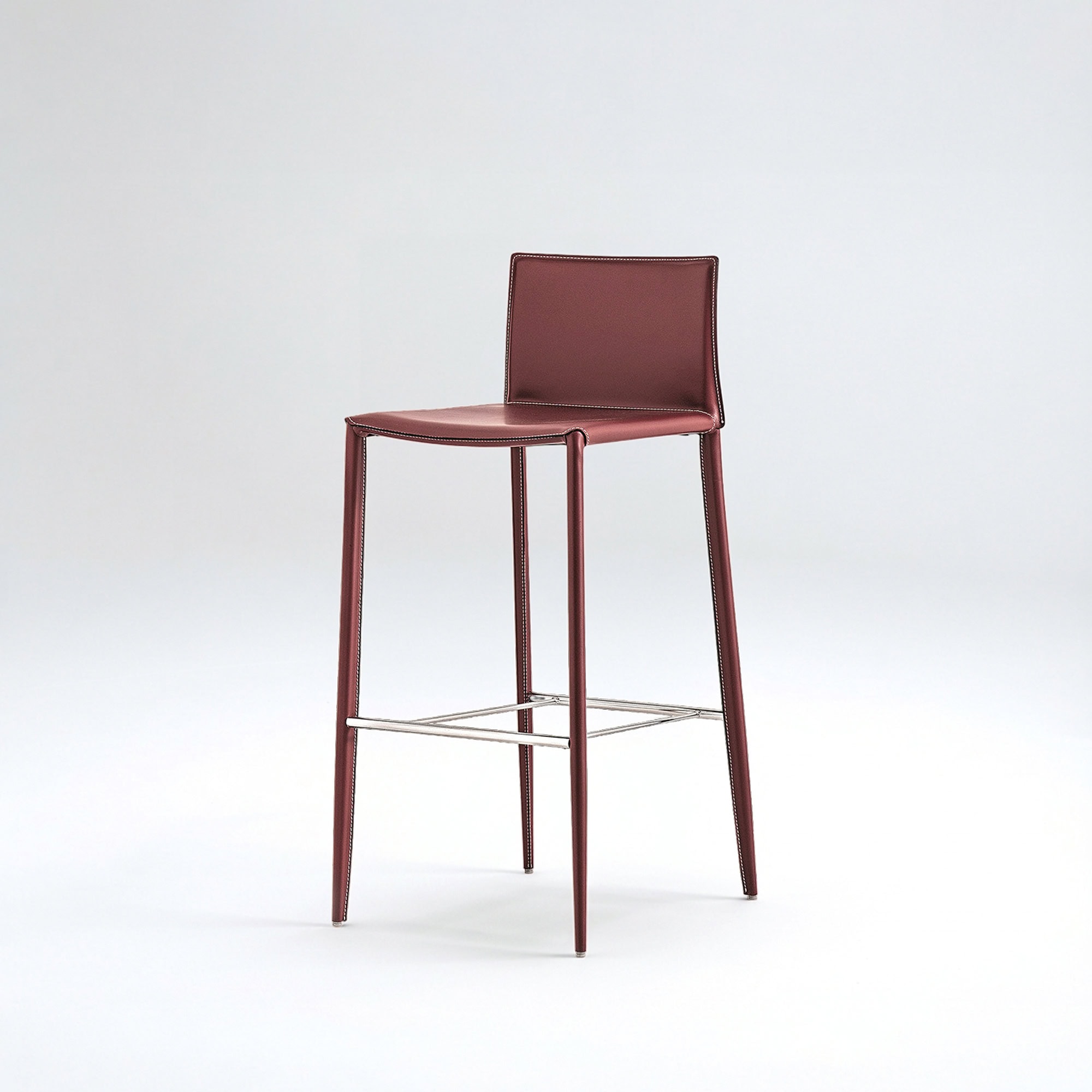 Sleek burgundy leather bar stool featuring chrome accents, ideal for contemporary kitchens and bars.