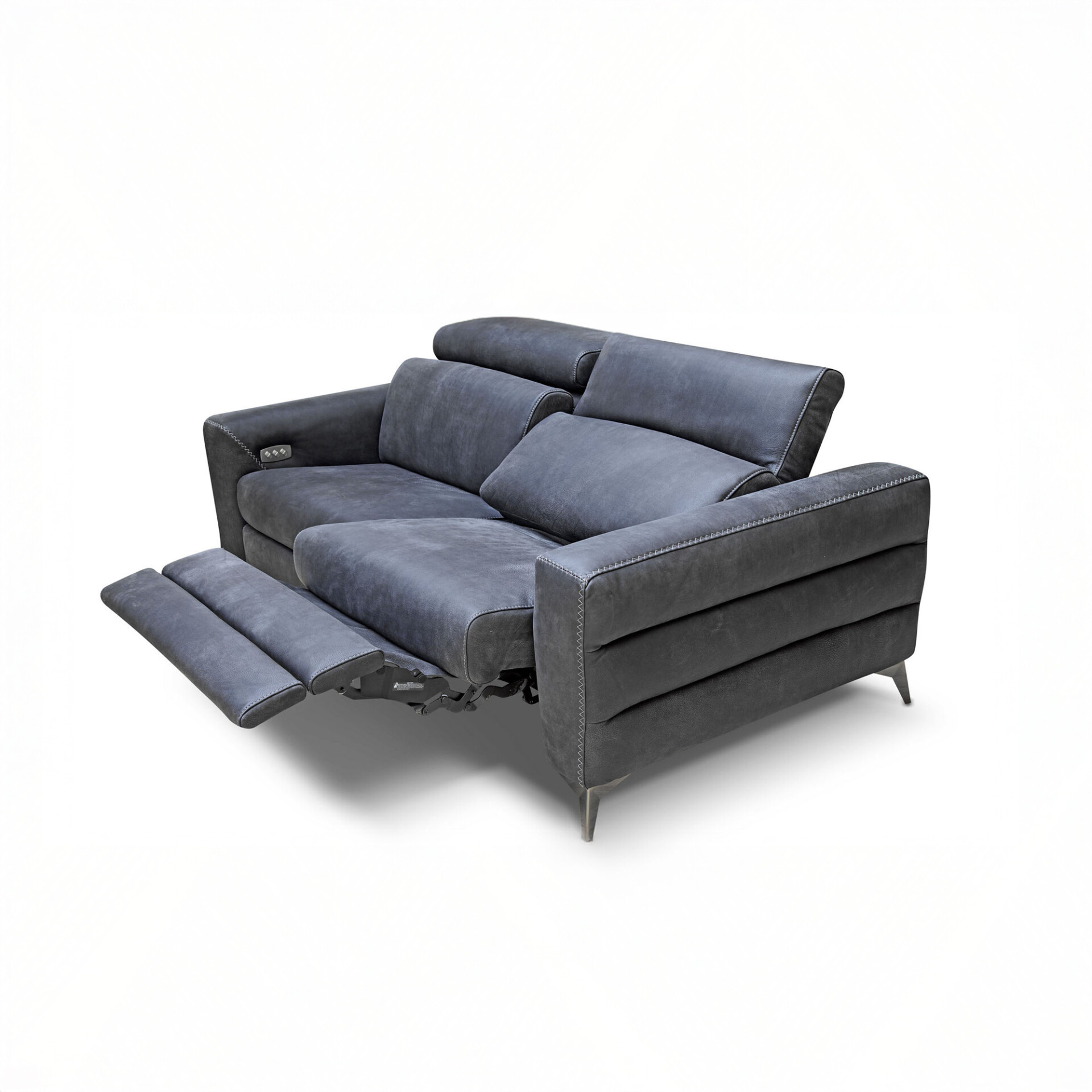 A dark grey modern two-seater reclining sofa with the left footrest extended, against a white background.