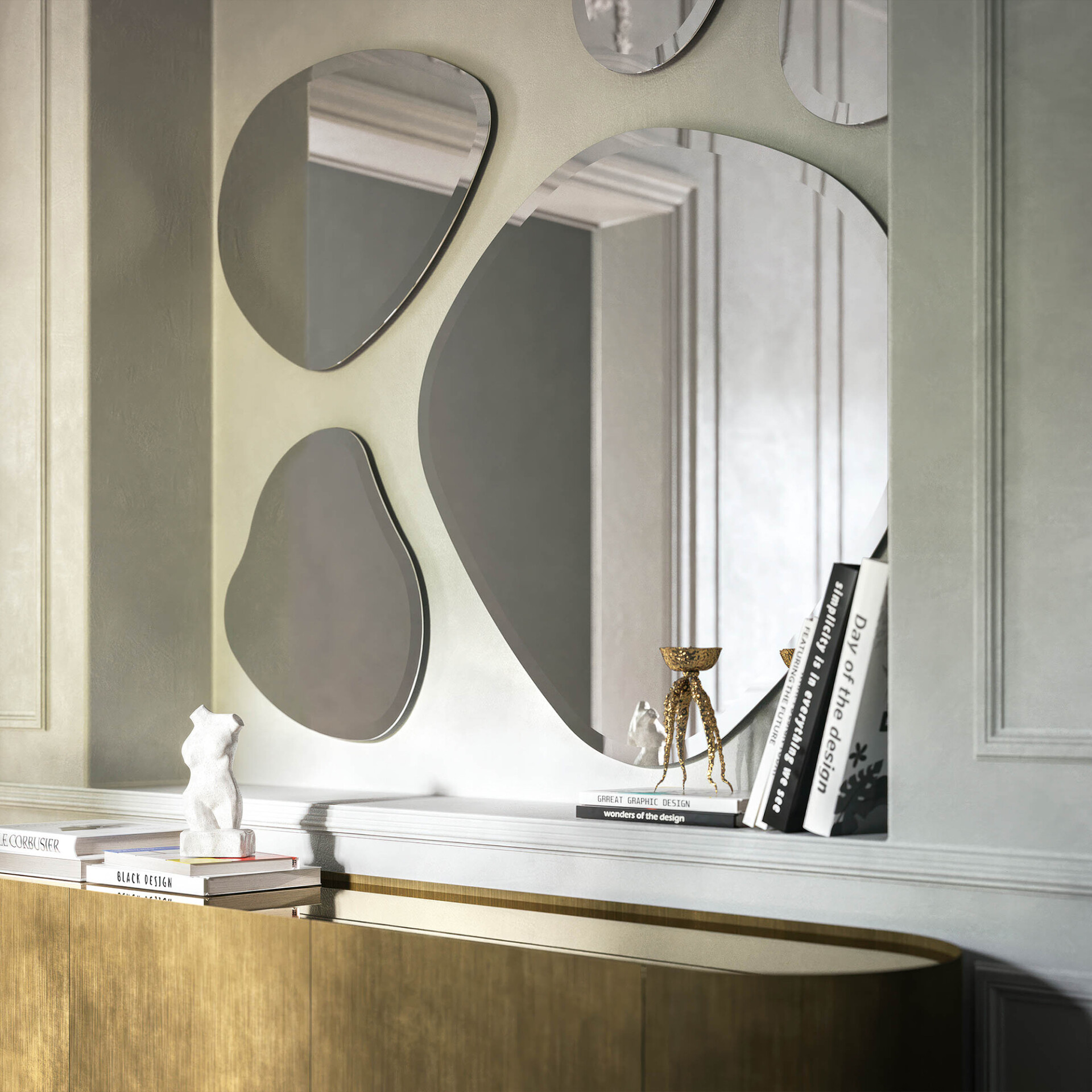 A modern wall display with multiple organic-shaped mirrors, a white shelf holding a white bust sculpture, design books, and a golden decorative object, above a golden-brown cabinet.