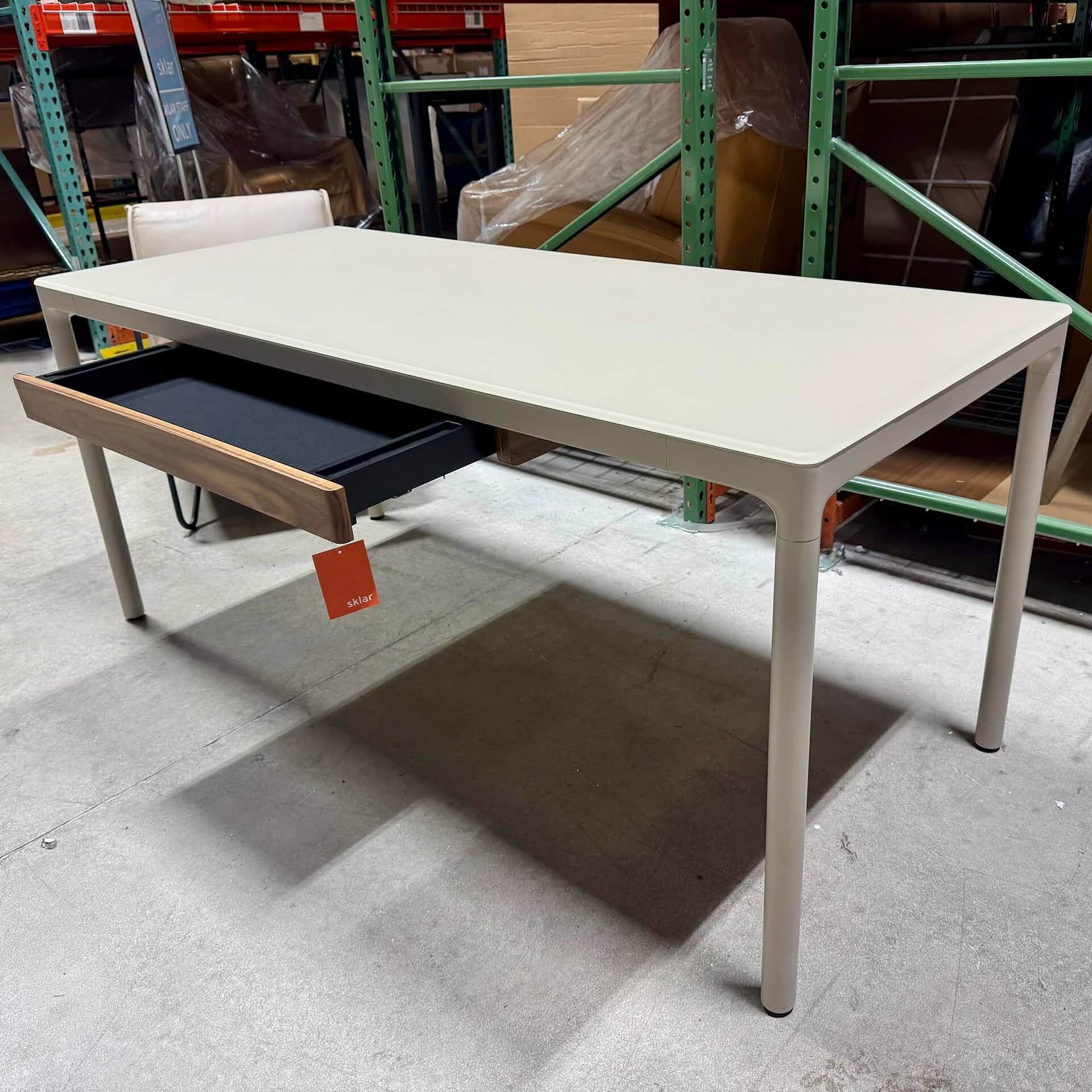 Stylish modern white desk with black tray and wooden accents, perfect for contemporary offices or home use.