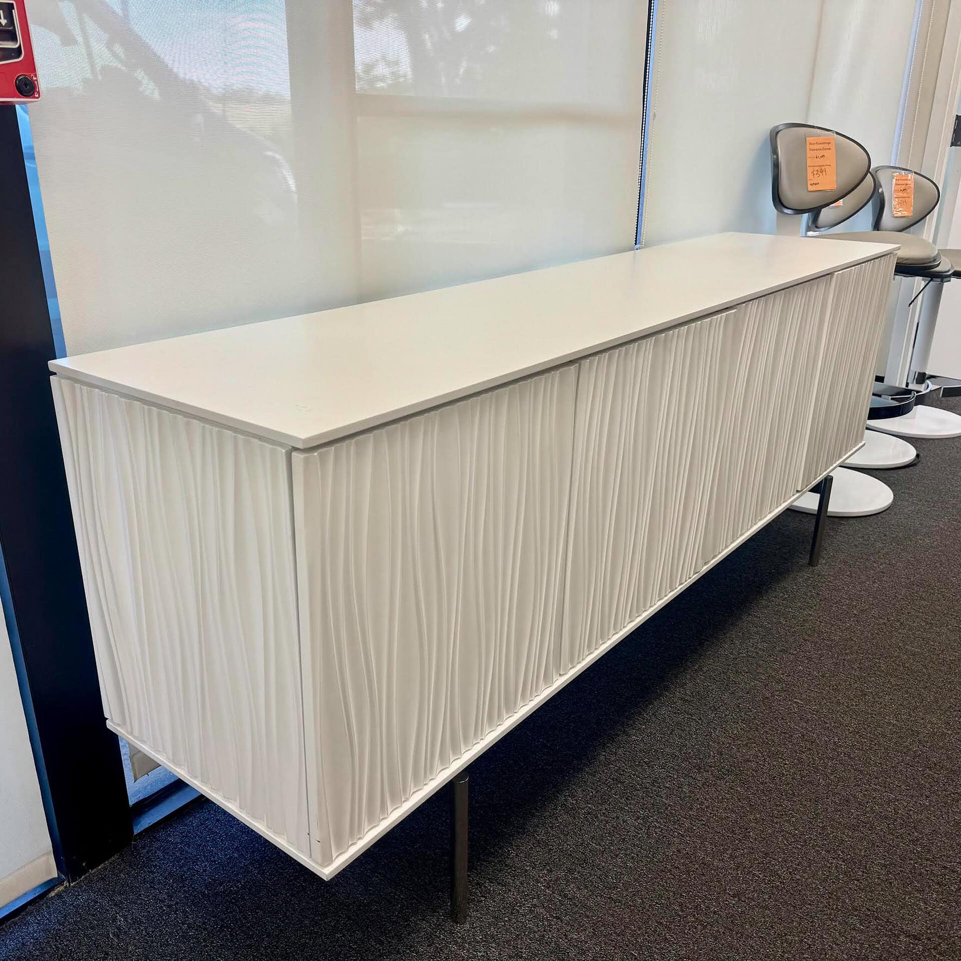 Elegant white storage cabinet featuring unique textured door design, perfect for contemporary spaces.