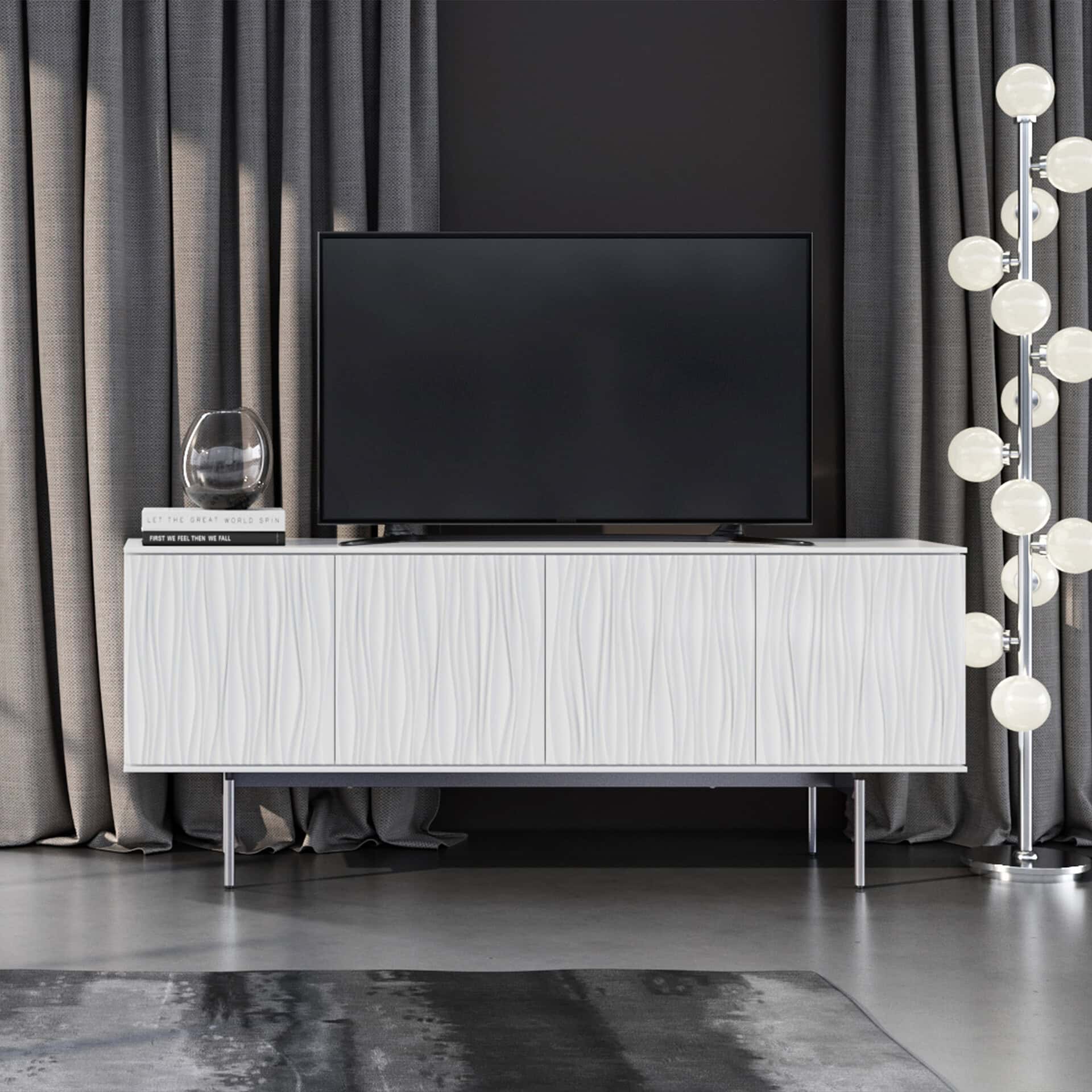 Elegant white TV stand with textured panels, metal feet, and contemporary design for stylish living room setup.
