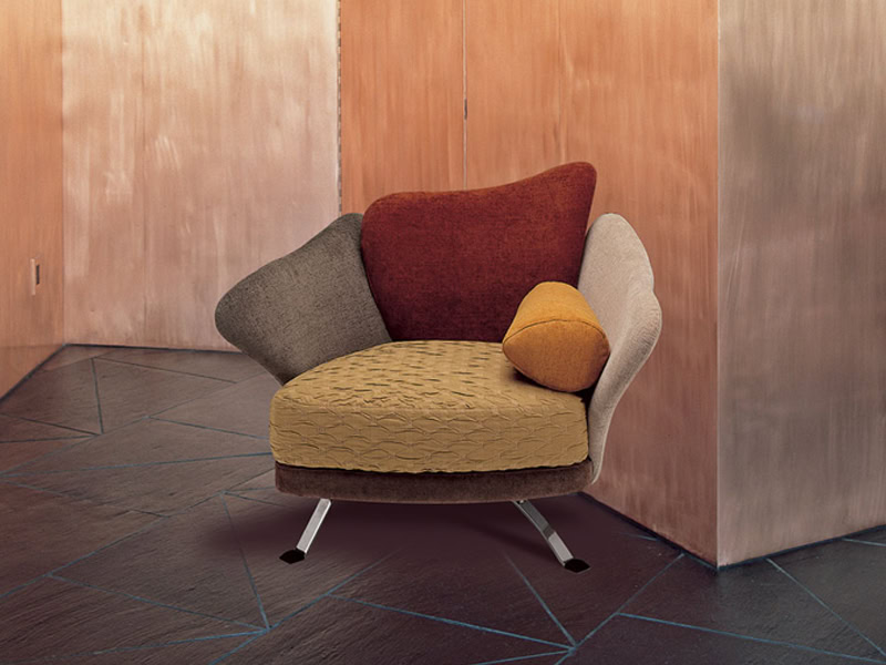 Brightly colored modern armchair with multicolored cushions, stylish design, perfect for living room or lounge.