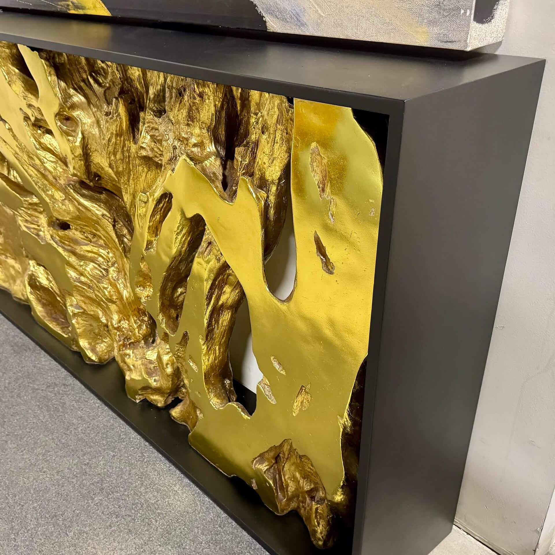 Elegant modern art sculpture featuring bold gold accents and sleek black frame design.