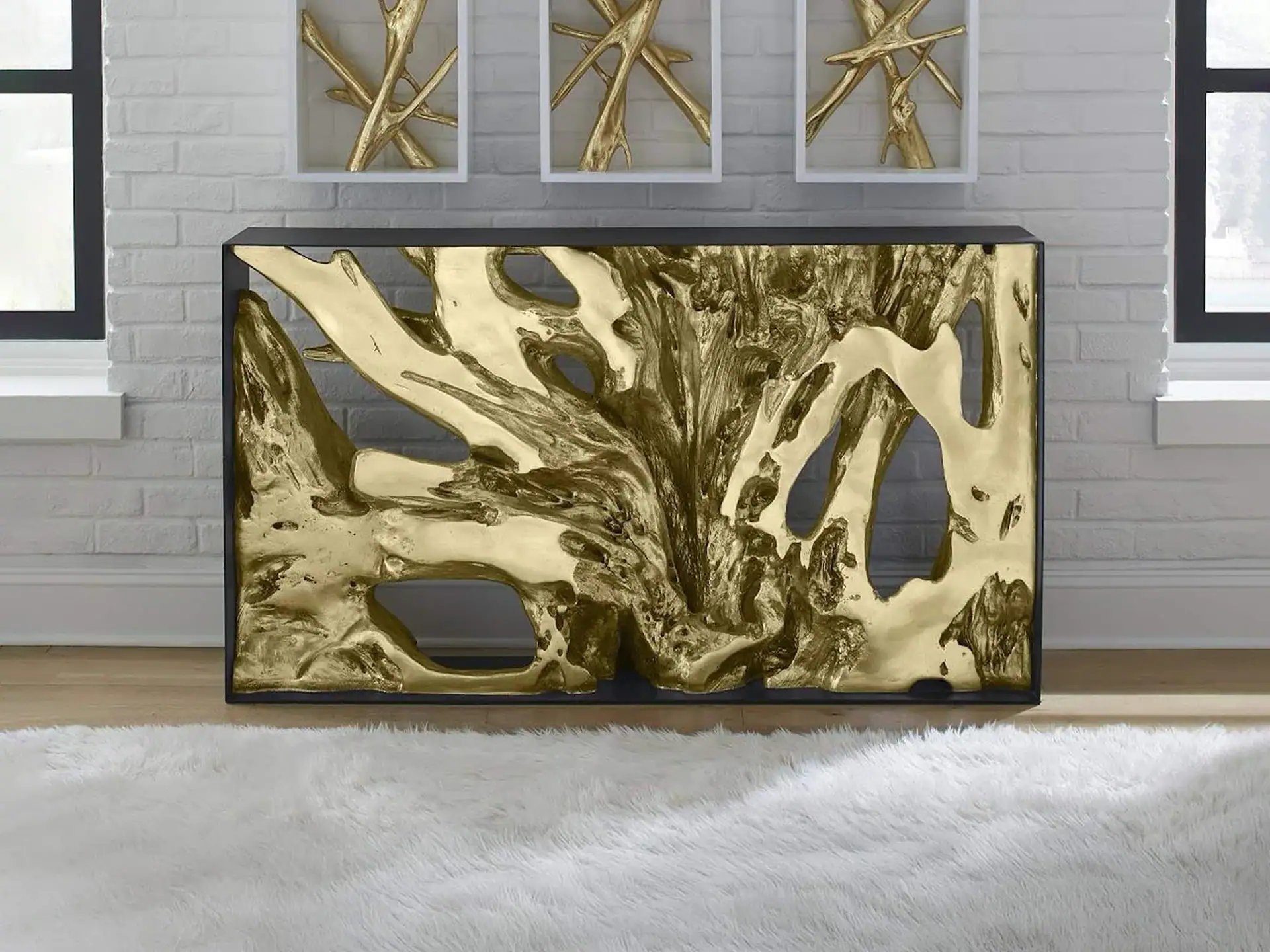 Elegant gold leaf console table with black frame in modern living room.