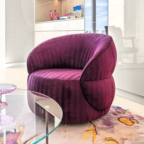 Elegant purple velvet accent chair in a modern condo interior.