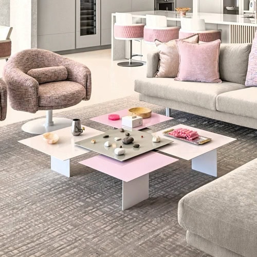 Contemporary condo living room with pink and gray furniture and stylish decor.