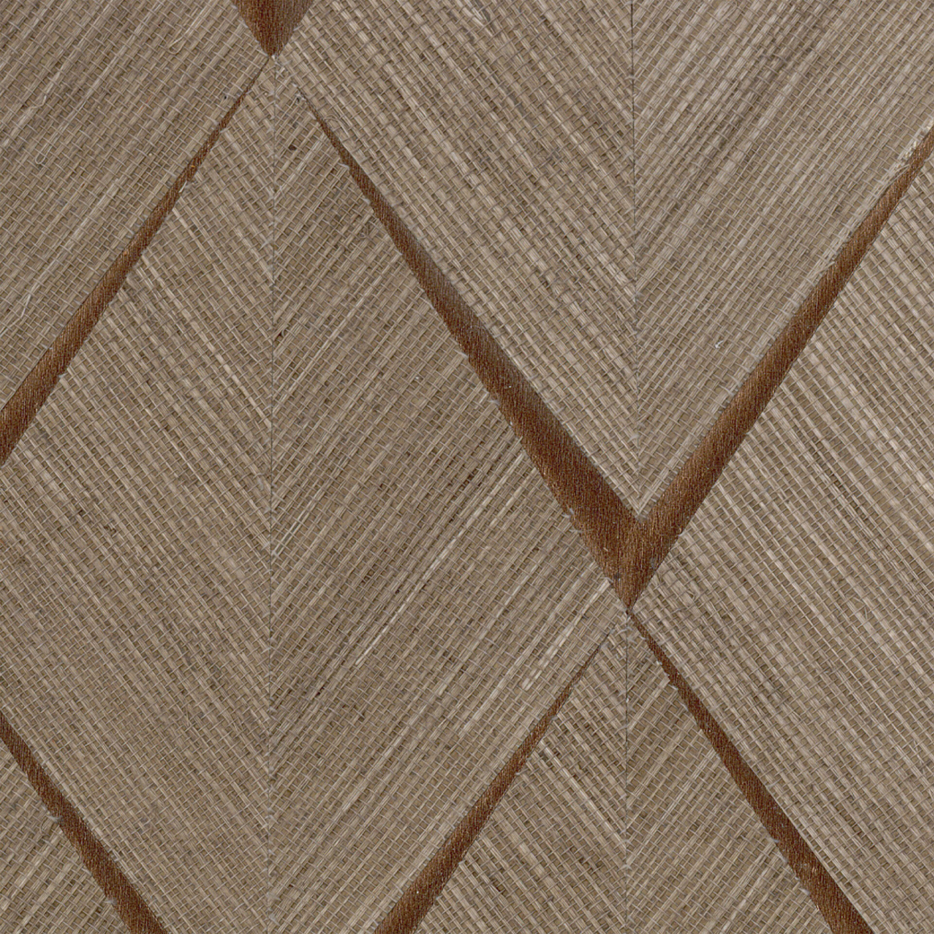 Close-up of a woven natural fiber texture in beige and brown, featuring a geometric diamond and chevron pattern formed by darker diagonal lines.