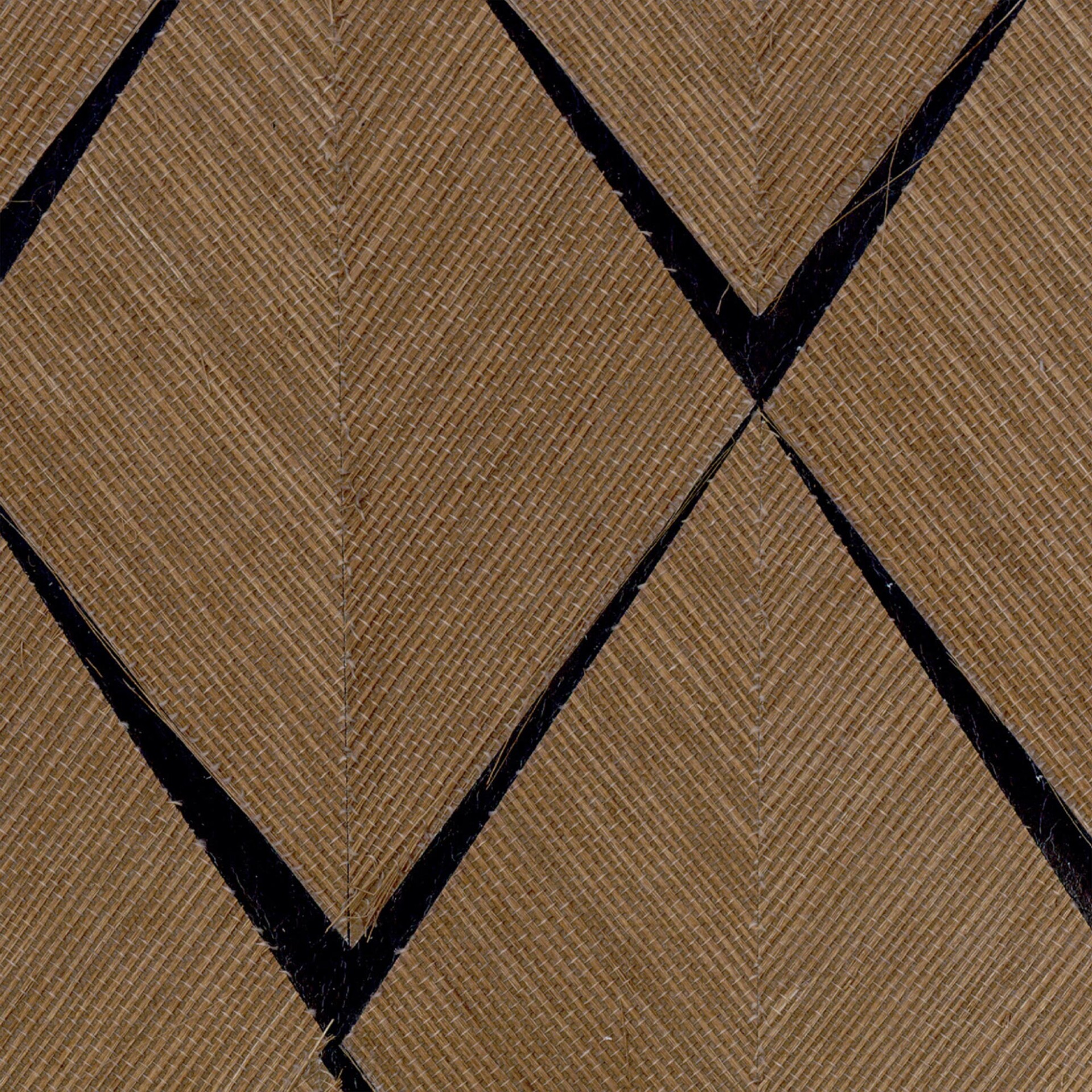 Close-up of a light brown woven mat with dark, intersecting diagonal lines forming a geometric pattern.