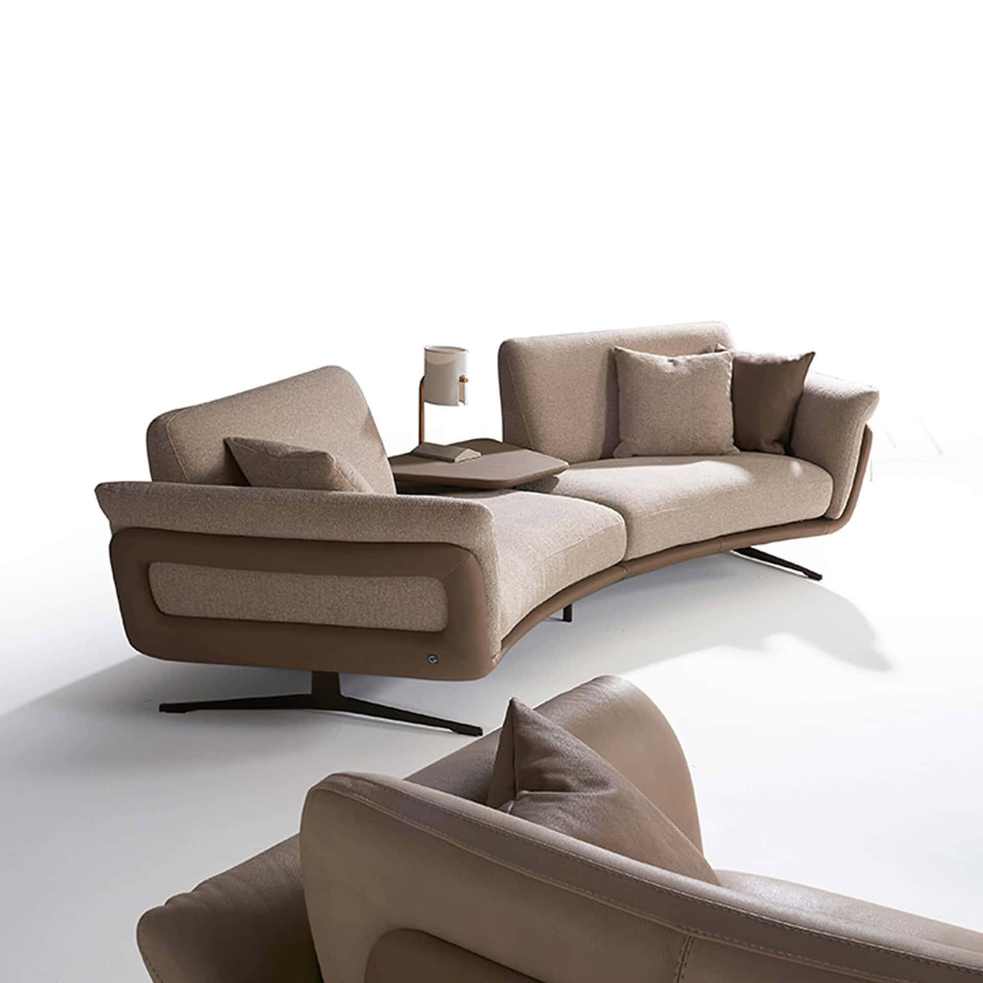 Sleek modern beige sofa with unique curved design and plush cushions for stylish comfort.