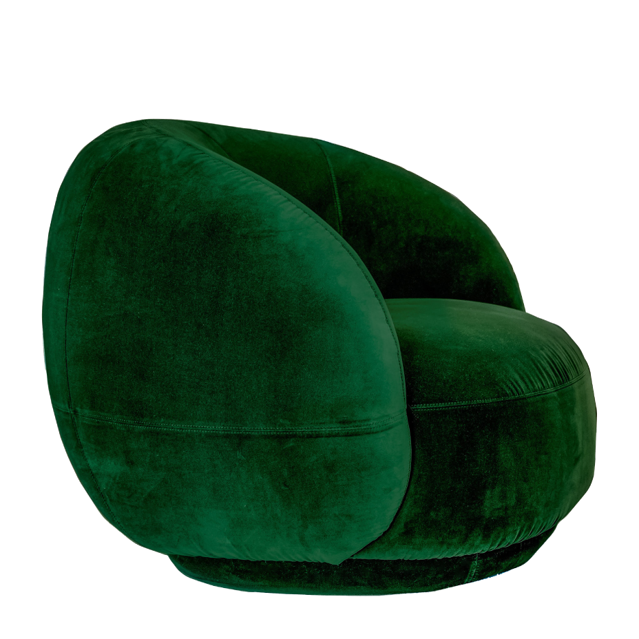 A modern, rounded emerald green velvet armchair with a plush texture and integrated base, isolated on a black background.