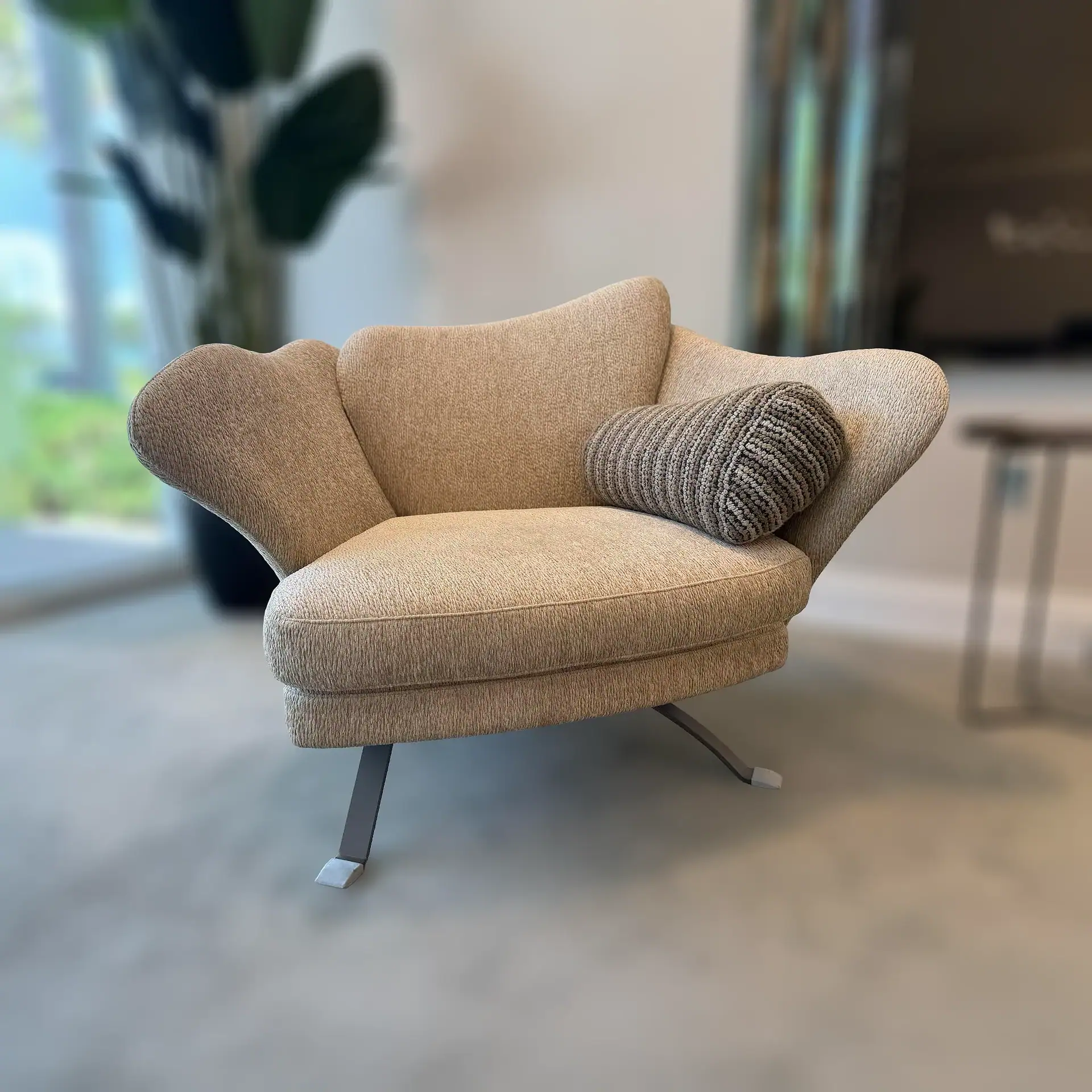 Sklar Furnishings Flower Armchair with cushion in a modern room.