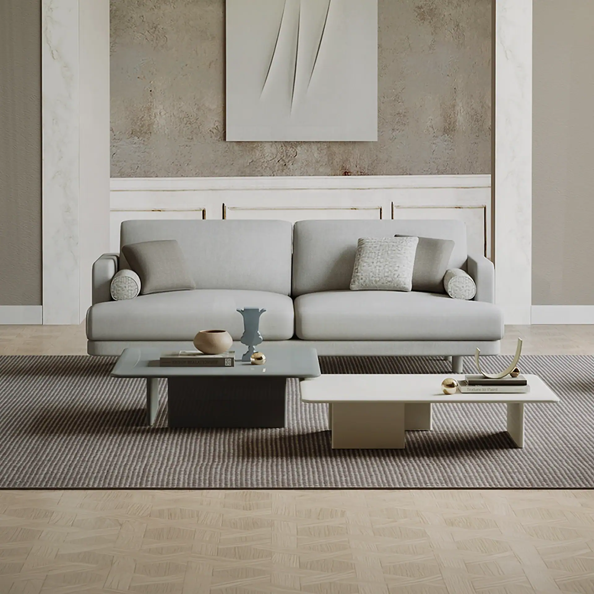 A modern living room with a light gray sofa, two rectangular coffee tables, and abstract wall art, set on a striped rug and parquet floor.
