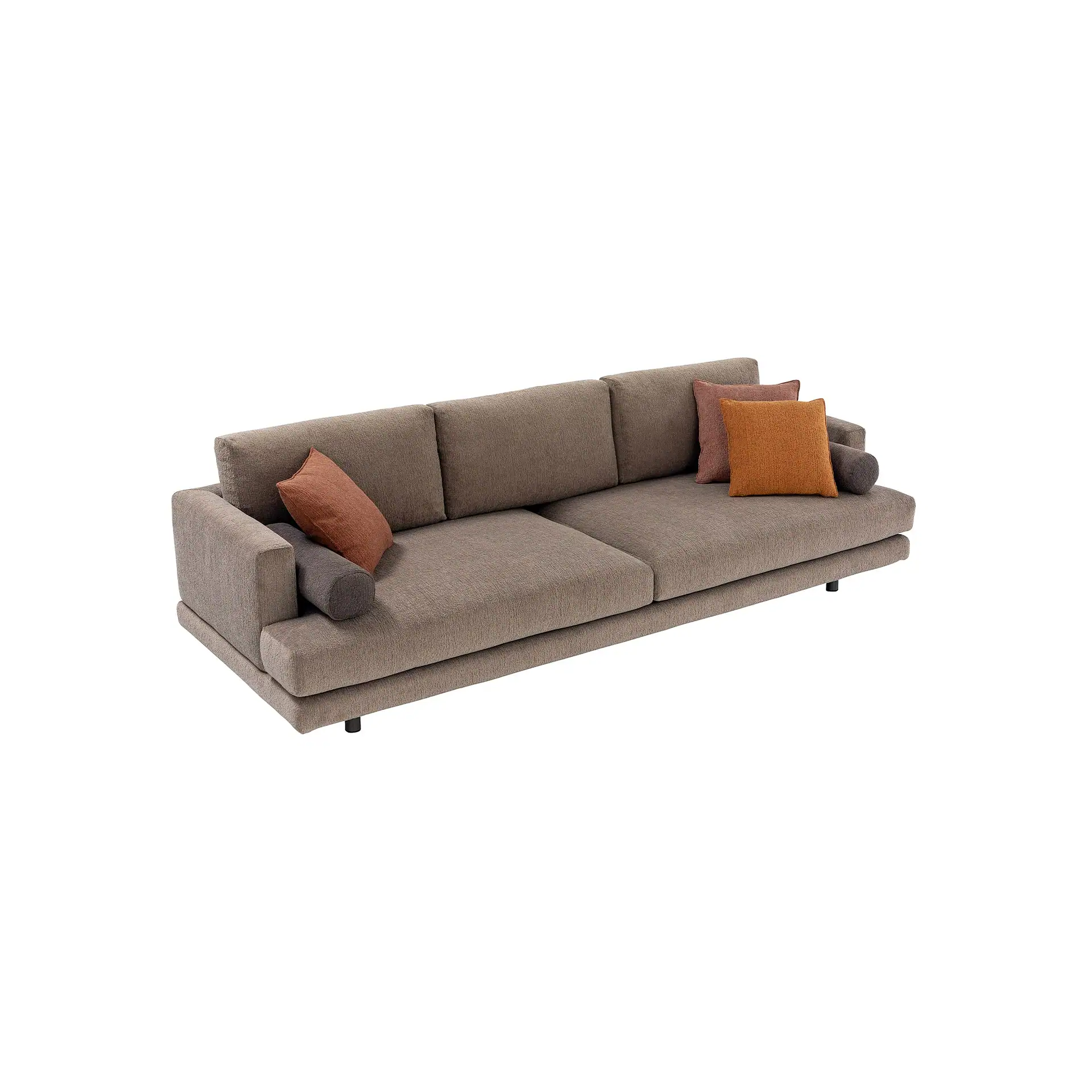 A modern, low-profile taupe sofa with three back cushions and two seat cushions. It is adorned with rectangular throw pillows in muted orange-brown, pinkish-brown, and bright orange, plus a dark gray bolster pillow.