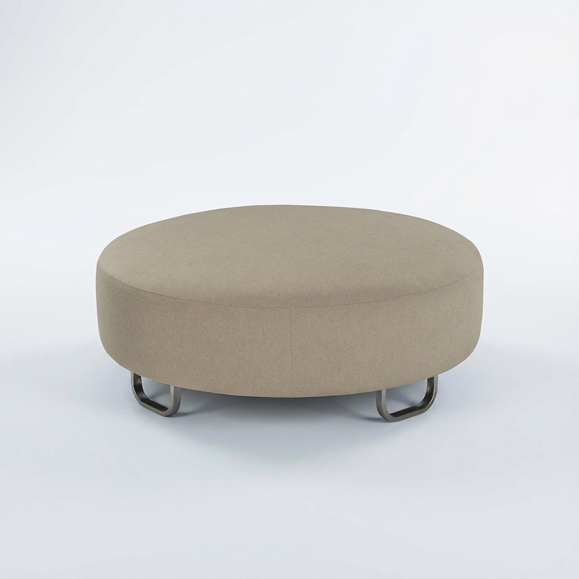 A round, light beige upholstered ottoman with dark, U-shaped metal legs on a white background.