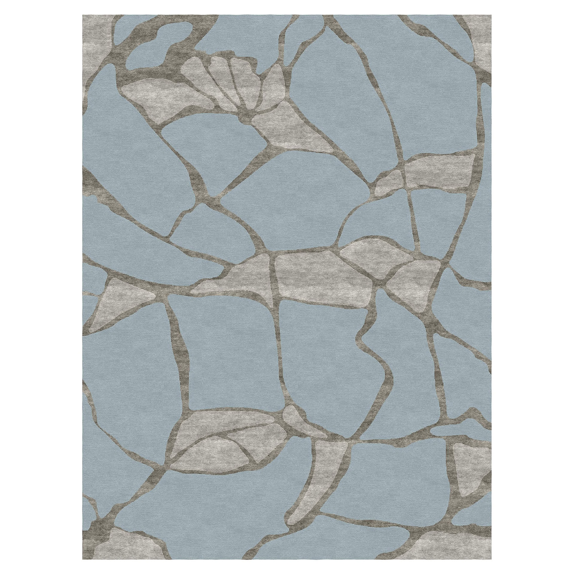 A rectangular rug with an abstract, organic pattern in light blue and various shades of grey.